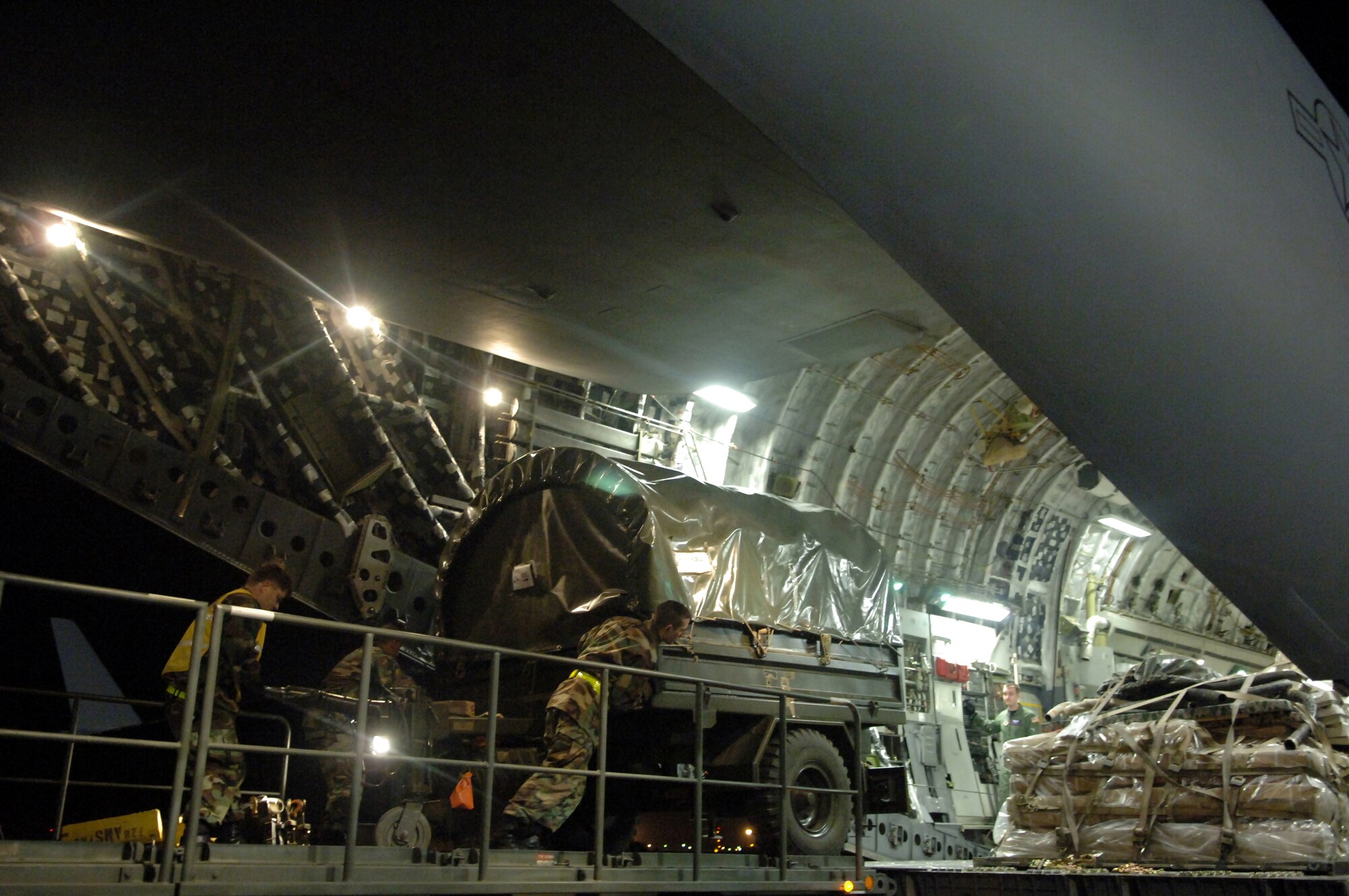 Airmen of the 728th Air Mobility Squadron load cargo on a C-17 Globemaster III late Tuesday night on Incirlik Air Base, Turkey. Team Incirlik moved 94,000 pounds of cargo in joint effort with its Turkish host to support the Afghan Army. (U. S. Air Force photo by Airman 1st Class Nathan W. Lipscomb)