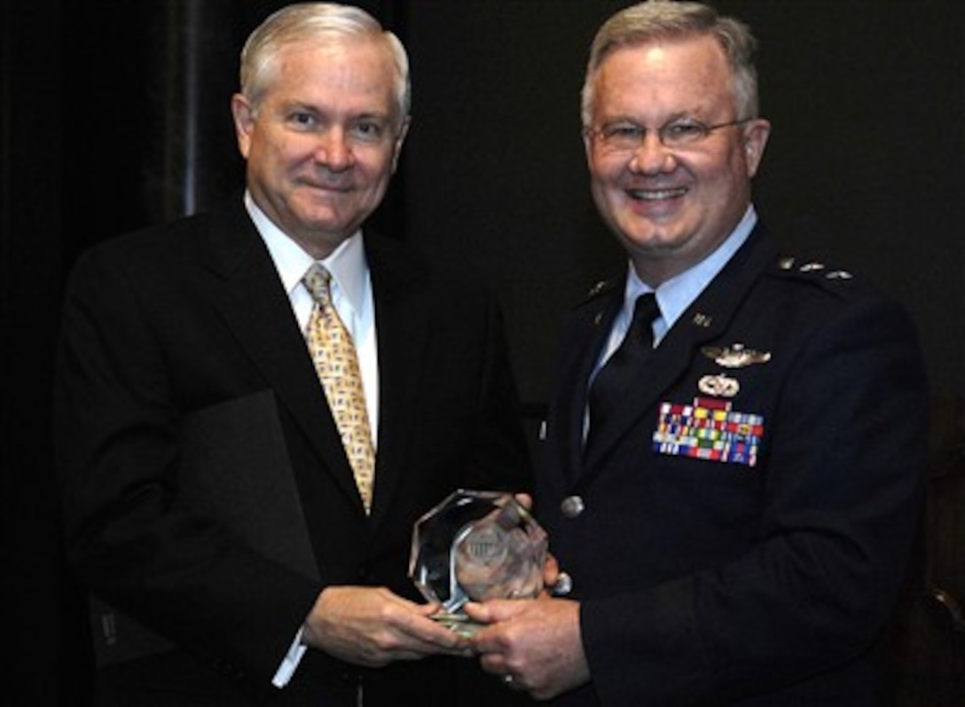 Air Force Maj. Gen. Roger P. Lempke presents an award to Defense Secretary Robert Gates at the National Guard Bureau's Senior Leadership Meeting in Washington, D.C., Feb. 27, 2007.
