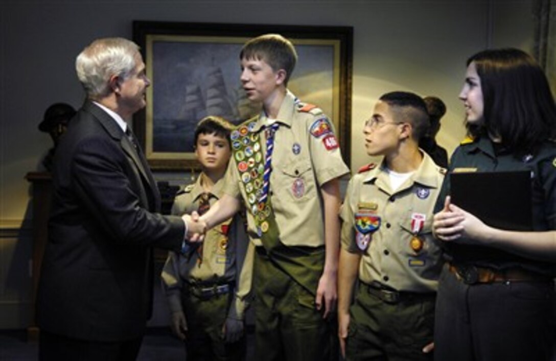 Secretary of Defense Robert M. Gates (left) shakes hands with Eagle Scout Michael Ward of the Boy Scouts of America in the Pentagon in Arlington, Va., on Feb. 26, 2007.  A delegation of Scouts presented Gates a copy of their Report to the Nation, which highlights the achievements of the Boy Scouts of America values-based program.  Ward is a Scout from the Grand Canyon Council in Arizona.  Scout Bryson Hicks (2nd from left) Scout Juan Ramirez (2nd from right) and Maggie Bellie (right) met with Gates in the Pentagon. 