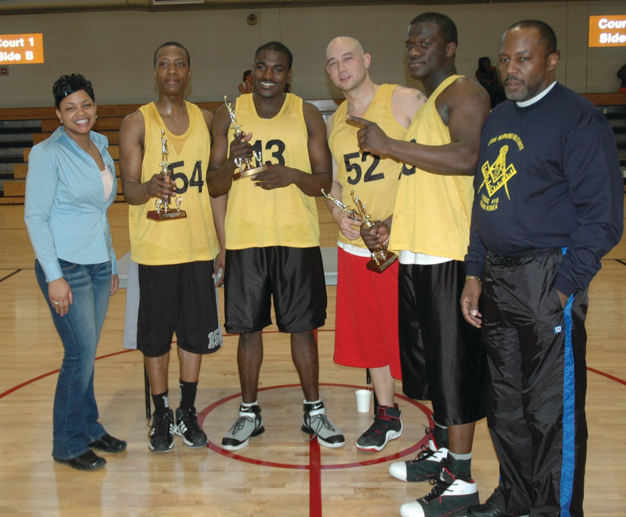 OSAN AIR BASE, Republic of Korea --  Jamie Sullivan, Brian Commodore, Frank Reyes and William Jackson, members of “The Winners,” stand with Malaysia Gresham (left), the African American Heritage Month Committee president, and Timothy Finney (right), the Otis Hopkins Military Lodge No. 10 president.  The team poses with their trophies after winning the a 3-on-3 basketball tournament Feb. 19. The AAHMC, along with the Otis Hopkins Military Lodge and Order of Eastern Stars, sponsored the tournament. (U.S. Air Force photo by Senior Airman Brok McCarthy)