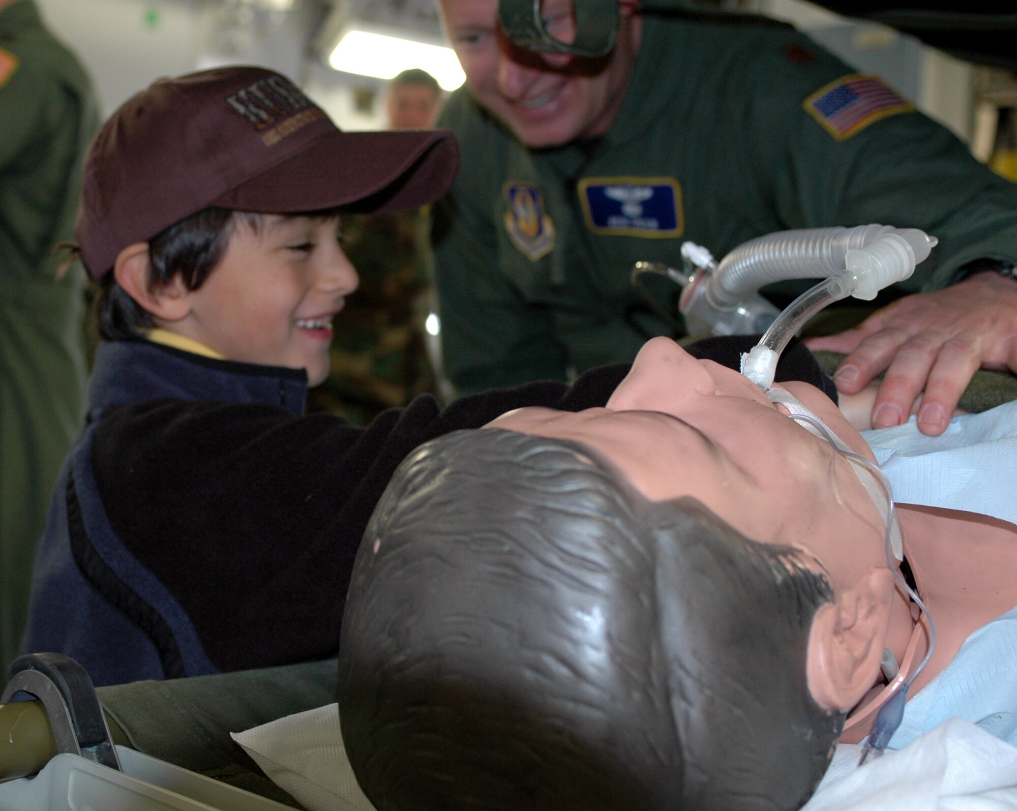 Maj. Kenneth Tyler, 349th Aeromedical Evacuation Squadron, shows Michael, 6, Ambassador Marcelle Wahba’s nephew, how medical equipment can help a patient breathe. The ambassador and her nephew toured the base Feb. 23. (U.S. Air Force photo by Staff Sgt. Candy Knight)