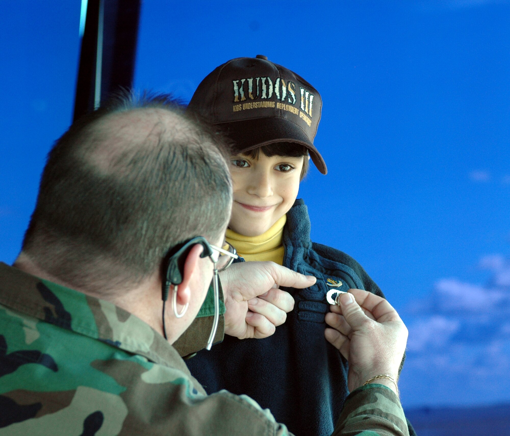 Tech. Sgt. David Sharp, 60th Operations Support Squadron tower controller, pins the air traffic controller career badge on Michael, 6, Ambassador Marcelle Wahba’s nephew, making him an honorary air traffic controller. Michael and the ambassador toured Travis Feb. 23 and met personnel from the 60th Operations, the 349th Aeromedical Evacuation Squadron and the 60th Aerial Port Squadron. (U.S. Air Force photo by Staff Sgt. Candy Knight)