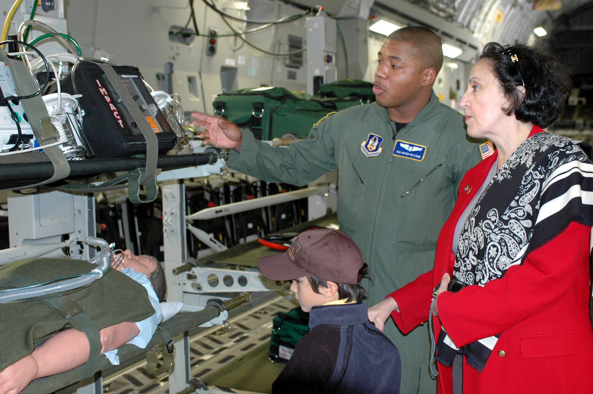 Senior Airman De Von Hilliard, 349th Aeromedical Evacuation Squadron, explains to Ambassador Marcelle Wahba how aeromedical equipment is used when transporting patients on a C-17 aircraft during the ambassador’s visit Feb. 23. (U.S. Air Force photo by Staff Sgt. Candy Knight)
