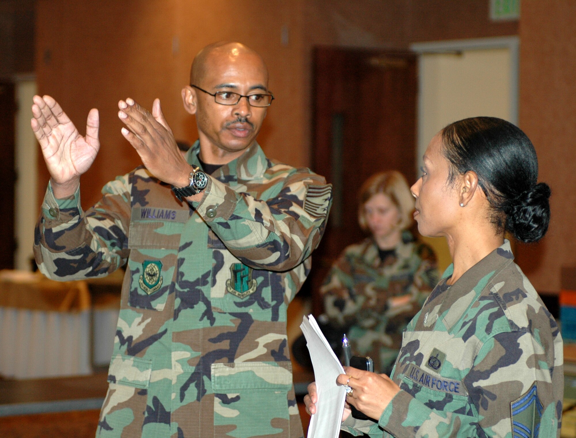 Chief Master Sgt. Michael Williams, 60th Air Mobility Wing command chief, discusses entrance techniques with Senior Master Sgt. Dawneen Williams, 60th Contracting Squadron, during the 60th Air Mobility Wing Annual Awards Banquet rehearsal Feb. 26. The chief encourages all of Team Travis to take the time and recognize the hard work their Airmen do every day. (U.S. Air Force photo by Staff Sgt. Candy Knight)
