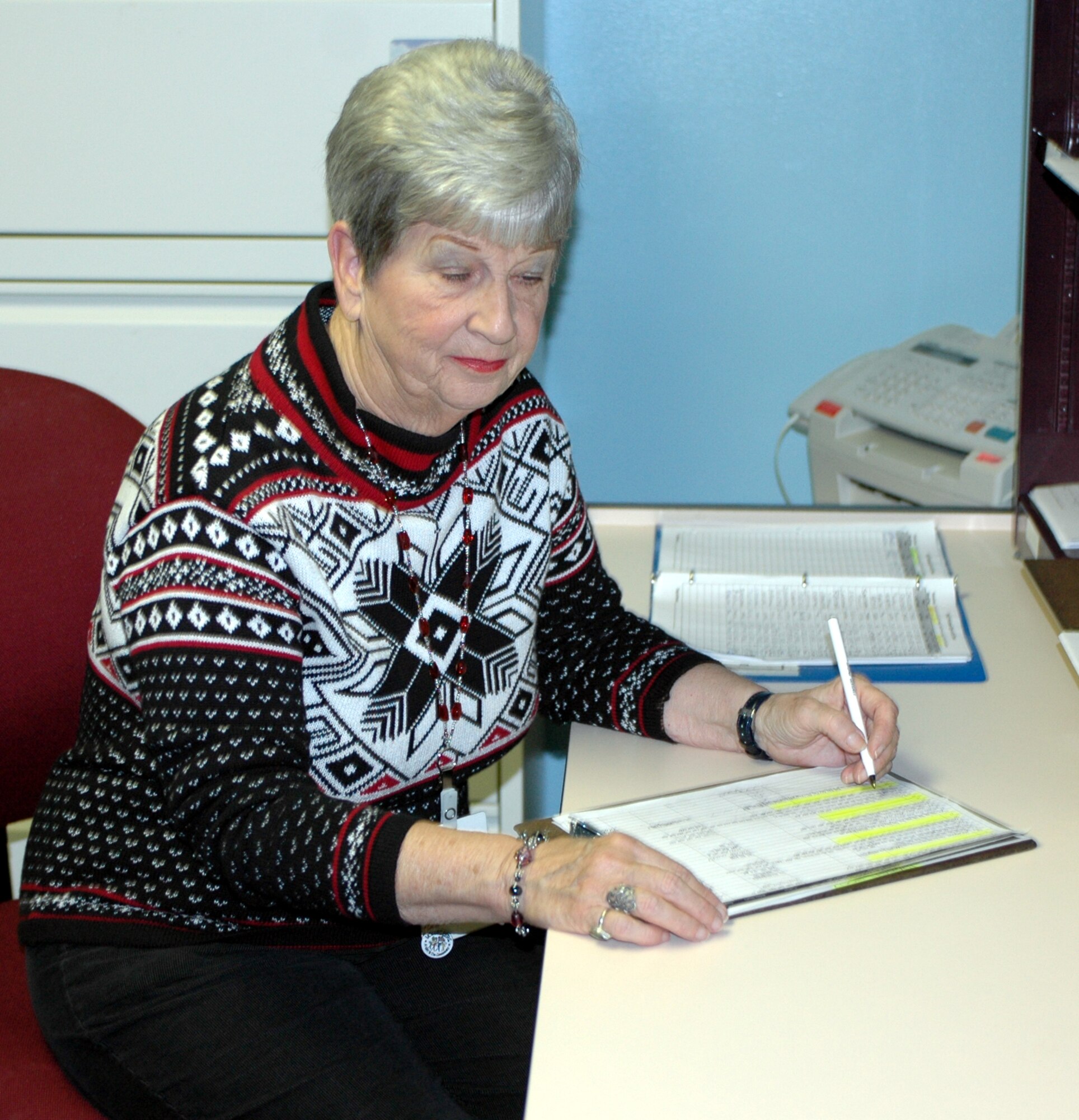 Mrs. Marlene Paulson, David Grant USAF Medical Center chapel volunteer, fills out paperwork. For 23 years, she has volunteered at the DGMC where she assists and comforts patients, and their families during stressful medical times. (U.S. Air Force photo by Airman Kristen Rohrer)