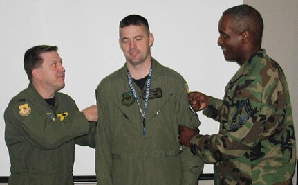 Master Sgt. Keith Briggs, 437th Operations Group NCO in charge of special operations communications, gets his new stripes from Colonel Joerger and Chief Willis at wing headquarters building recently. (Courtesy photo)