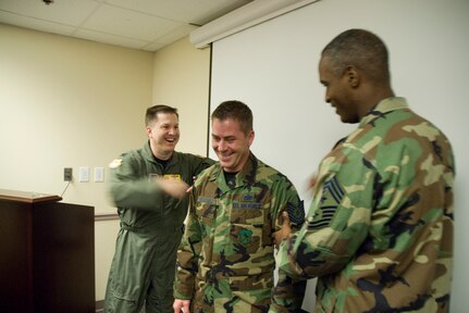 Tech. Sgt. Brandon Hutchins, 437th Aerial Port Squadron unit deployment manager and health monitor, gets his new stripes from Col. Glen Joerger, 437th Airlift Wing commander, and Chief Master Sgt. Melvin Willis, 437 AW command chief master sergeant, at the aerial port recently. (U.S. Air Force photo/Senior Airman Sam Hymas)