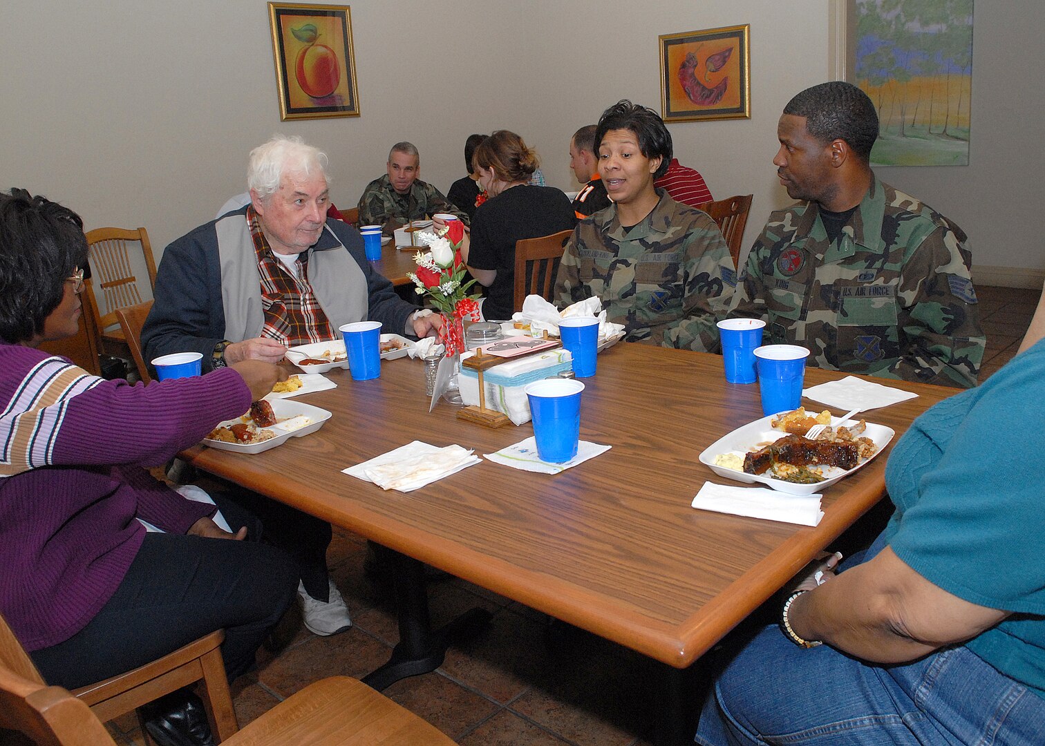 Ramana Lewis, left, Fisher House staff member, Howard Atwell, patient, Staff Sgt. Marcia Strickland-King, 37th Training Wing, and Staff Sgt. Gregg King, 37th Mission Support Squadron, share a meal at the Lackland Fisher House Feb. 15. The African-American Heritage Committee volunteered at the home on Lackland Air Force Base, Texas, as one of 10 planned activities in February, African-American History Month. (USAF photo by Robbin Cresswell)    