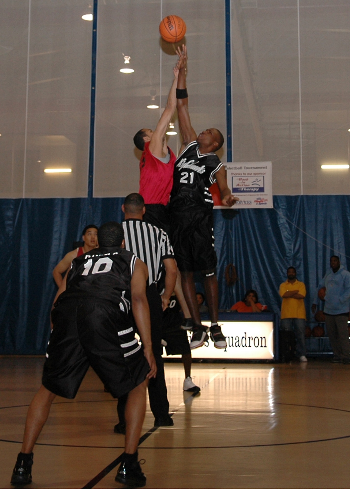 Holloman’s Akenty Frazerr tips the ball to Taress Daniels to start their tournament-opening game versus Cannon Air Force Base at the 49th Services Squadron’s Fitness and Sports Center. Holloman won the game 87-77, but Cannon had their revenge later in the tournament when they beat the Nighthawks to advance to the championship game. (U.S. Air Force photo by Airman 1st Class John Strong)
