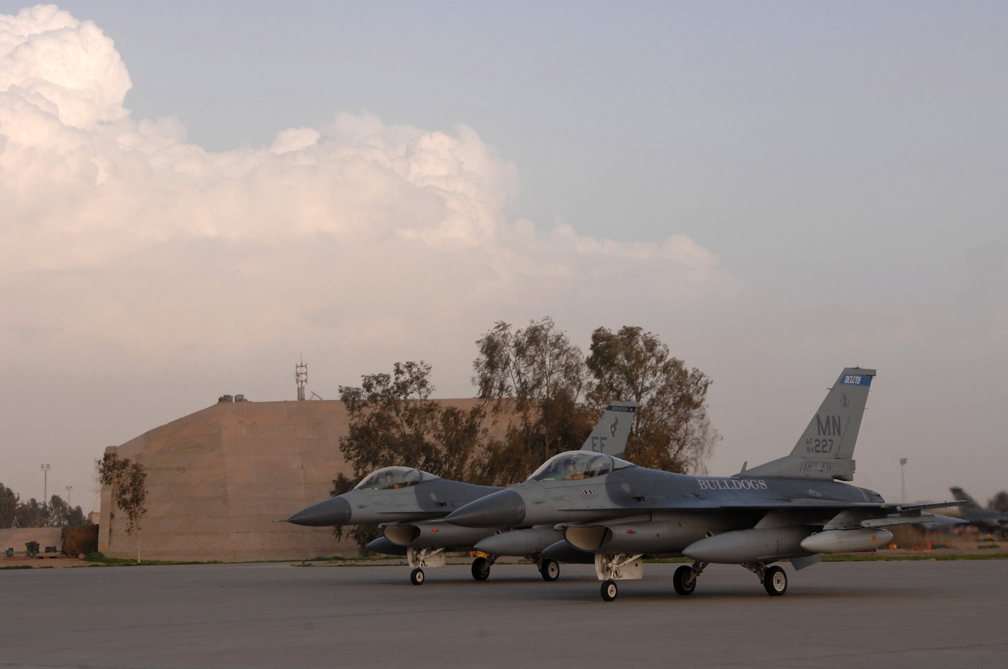 Two F-16 Fighting Falcons assigned to the 332nd Expeditionary Fighter Squadron sit on the ramp Feb. 26, after recently arriving in Balad Air Base, Iraq. The F-16s are deployed from the Minnesota Air National Guard's 148th Fighter Wing along with roughly 400 guardsmen in support of Operation Iraqi Freedom. (U.S. Air Force photo/Tech. Sgt. Julie M. Tomaska) 