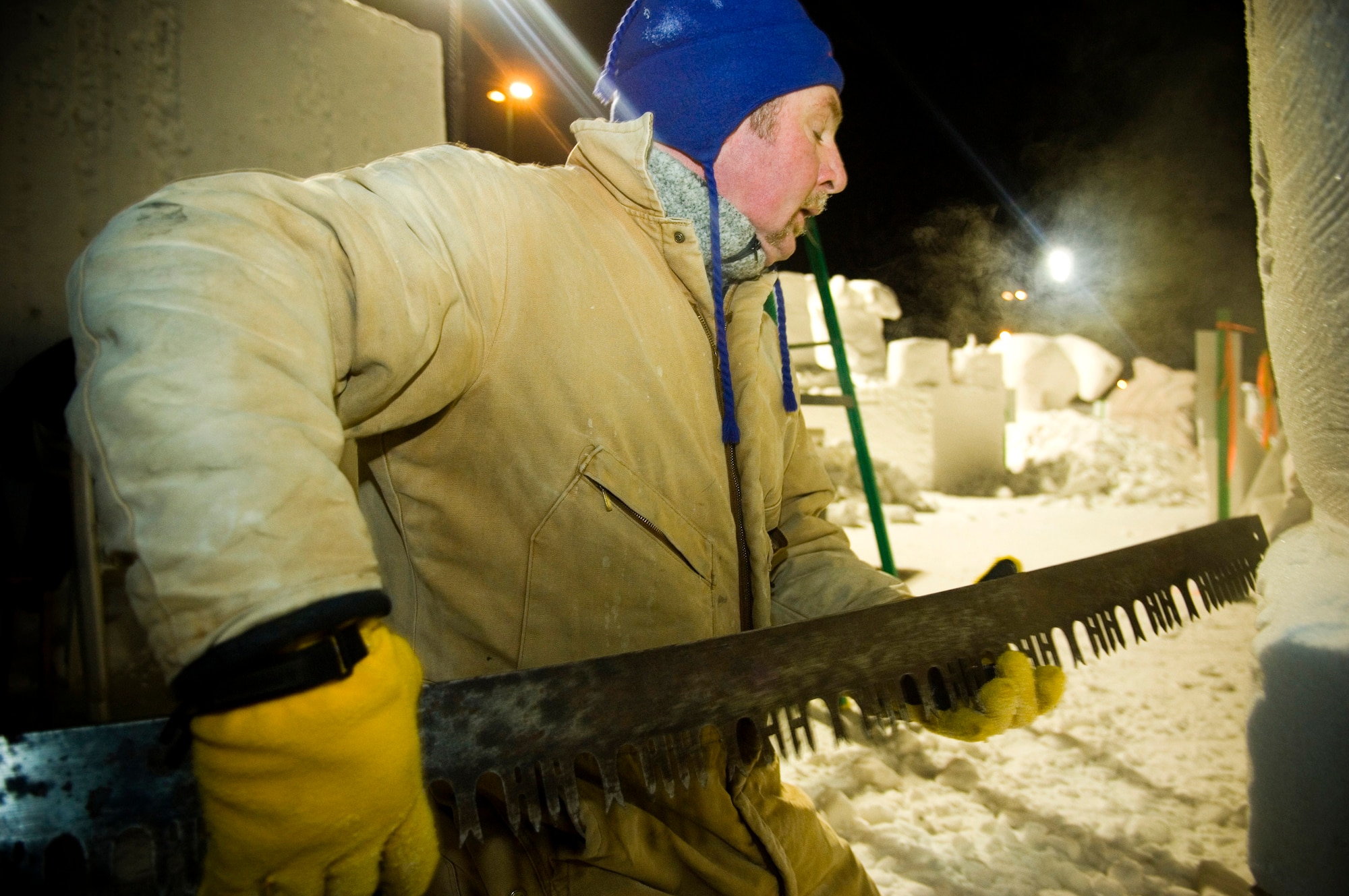 Eric Zimmerman, a member of the three-man Elmendorf Air Force Base snow-sculpting team, uses a saw to carve a snow block for a pirate ship Feb. 23 during the Anchorage, Alaska, Fur Rendezvous snow sculpture competition.  The team pushed through the exhaustion of freezing temperatures and long hours of labor to vie for a chance to be invited to the 2008 National Snow Sculpting Championship in Lake Geneva, Wis.  (U.S. Air Force photo/Senior Airman Garrett Hothan)