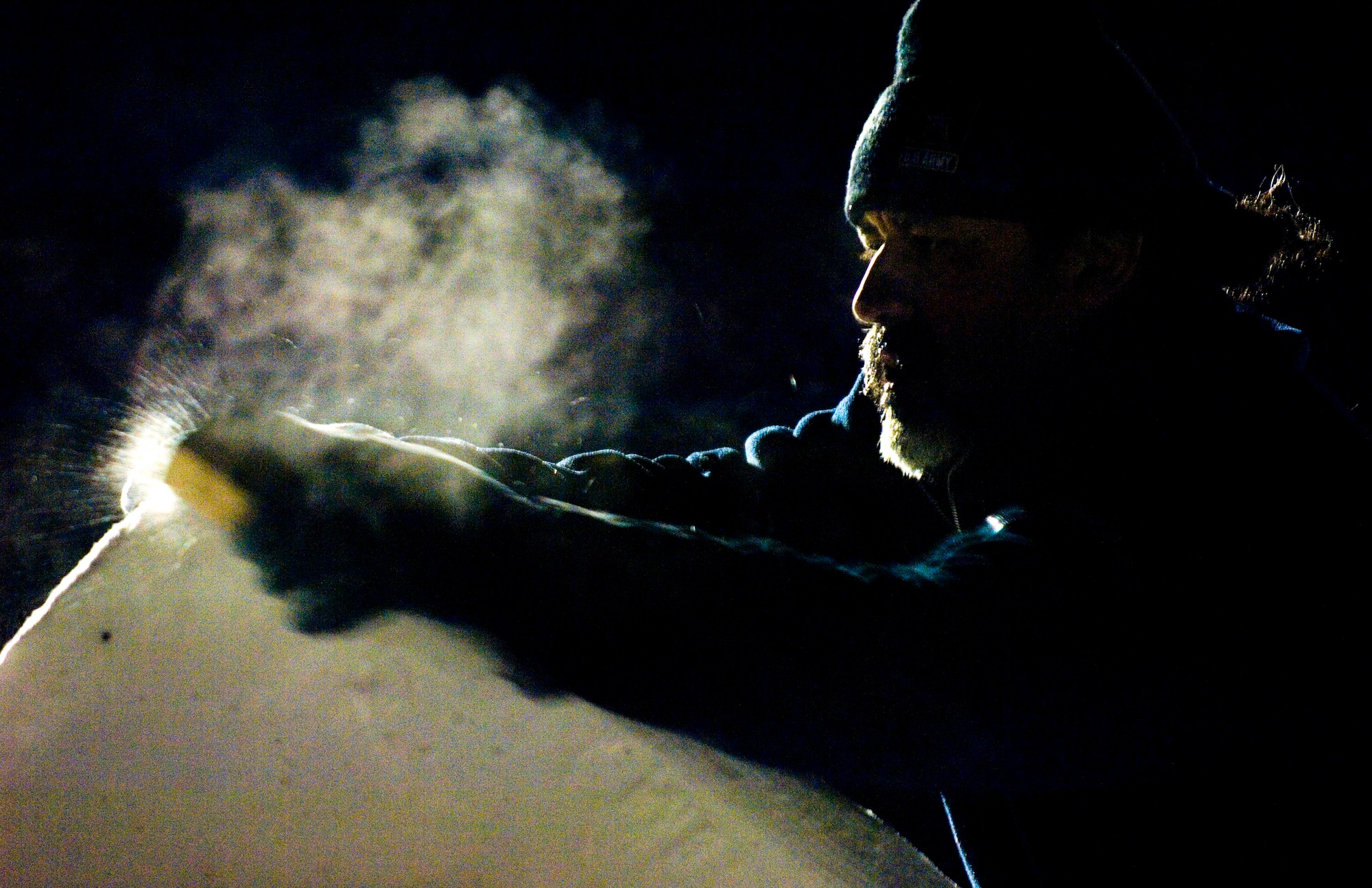Mitchell Manzo, a member of the three-man Elmendorf Air Force Base snow-sculpting team, carefully sculpts a dragon's head on the prow of a pirate ship Feb. 23 during the Anchorage, Alaska, Fur Rendezvous snow sculpture competition.  The team was vying for a chance to be invited to the 2008 National Snow Sculpting Championship in Lake Geneva, Wis.  Mr. Manzo is a chef with the 3rd Services Squadron.  (U.S. Air Force photo/Senior Airman Garrett Hothan)