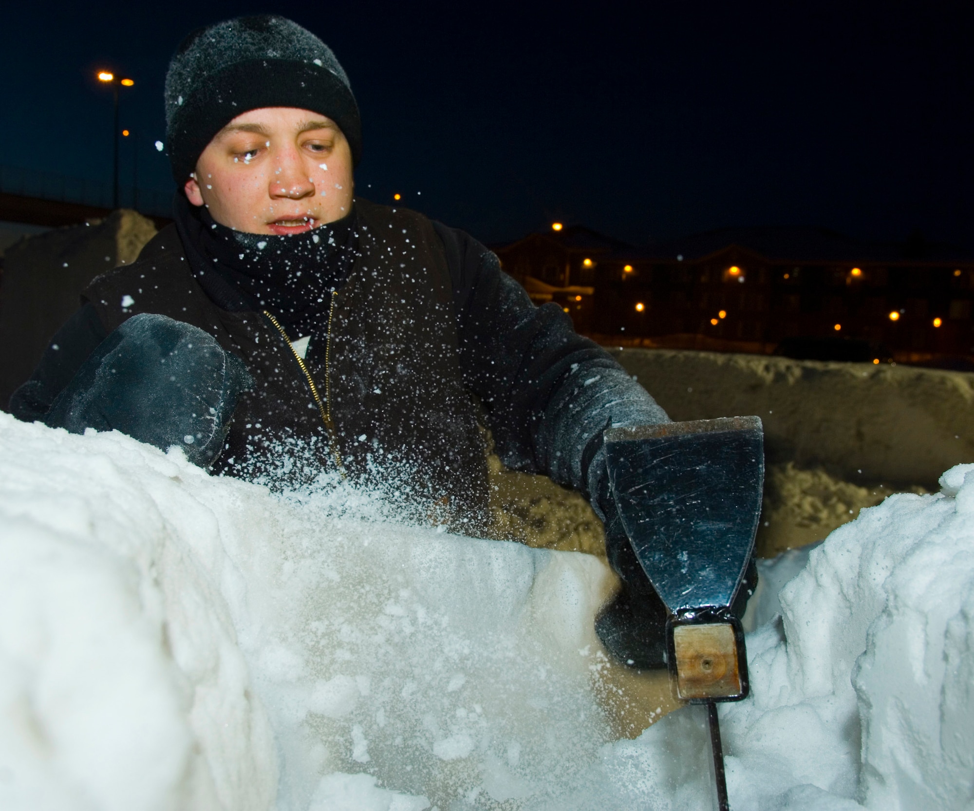 Staff Sgt. Edward Tompkins, a member of the three-man Elmendorf Air Force Base snow-sculpting team, hacks away at a block of snow carefully forming the stern of a pirate ship Feb. 23 during the Anchorage, Alaska, Fur Rendezvous snow sculpture competition.  The team was vying for a chance to be invited to the 2008 National Snow Sculpting Championship in Lake Geneva, Wis.  Sergeant Tompkins is assigned to the 3rd Services Squadron.  (U.S. Air Force photo/Senior Airman Garrett Hothan)