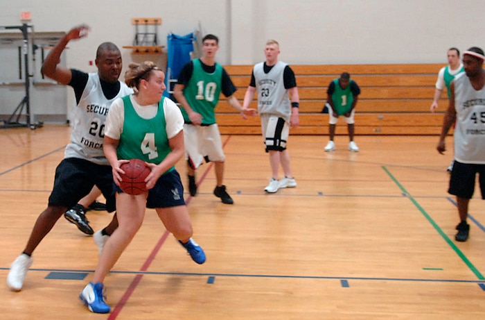 Emily Gross, AMXS, protects the ball from Mike Evans, SFS during the second half of the game. (U.S. Air Force photo/Airman 1st Class Nicholas Pilch)
