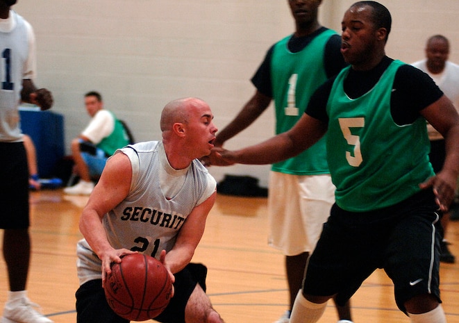Jeramy Ramsey, SFS, works the ball to the hoop while, Tyrone Herron, AMXS, plays defense. (U.S. Air Force photo/Airman 1st Class Nicholas Pilch)