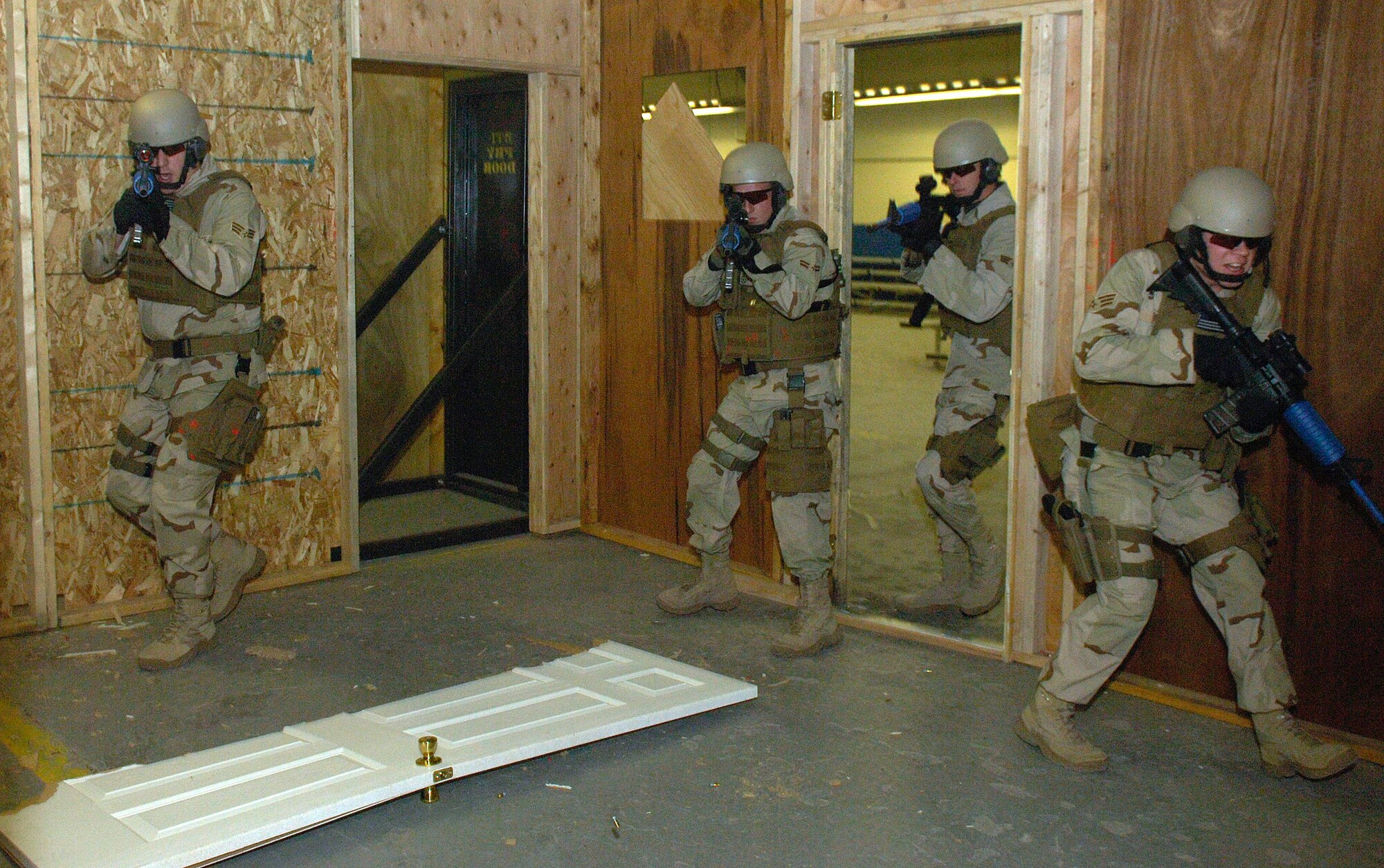 Airmen of the 90th Ground Training Squadron enter a room with a simulated hostage situation in place Feb. 8 at Camp Guernsey, Wyo. Once the enemy has been suppressed the hostage is quickly escorted away from the site. Camp Guernsey is an Army Reserve training ground used by the 90th Space Wing for convoy security, sniper training and close quarters combat training including other specialty training. (U.S. Air Force photo/Senior Airman Javier Cruz Jr.) 

