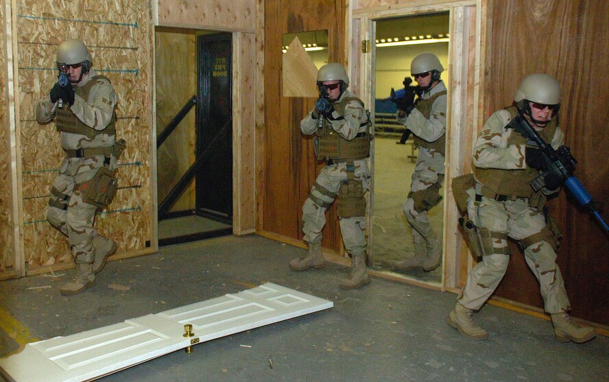 Airmen of the 90th Ground Training Squadron enter a room with a simulated hostage situation in place Feb. 8 at Camp Guernsey, Wyo. Once the enemy has been suppressed the hostage is quickly escorted away from the site. Camp Guernsey is an Army Reserve training ground used by the 90th Space Wing for convoy security, sniper training and close quarters combat training including other specialty training. (U.S. Air Force photo/Senior Airman Javier Cruz Jr.) 