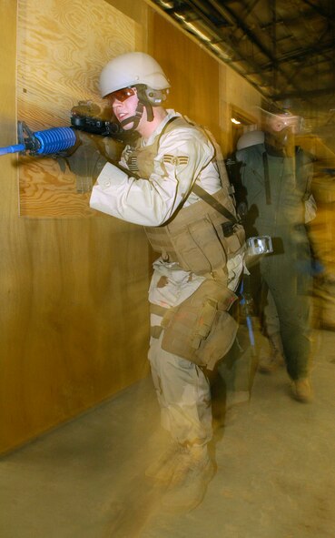 Airmen of the 90th Ground Training Squadron enter a room with a simulated hostage situation in place Feb. 8 at Camp Guernsey, Wyo. Once the enemy has been suppressed the hostage is quickly escorted away from the site. Campt Guernsey is an Army Reserve training ground used by the 90th Space Wing for convoy security, sniper training and close quarters combat training including other specialty training. (U.S. Air Force photo/Senior Airman Javier Cruz Jr.) 
