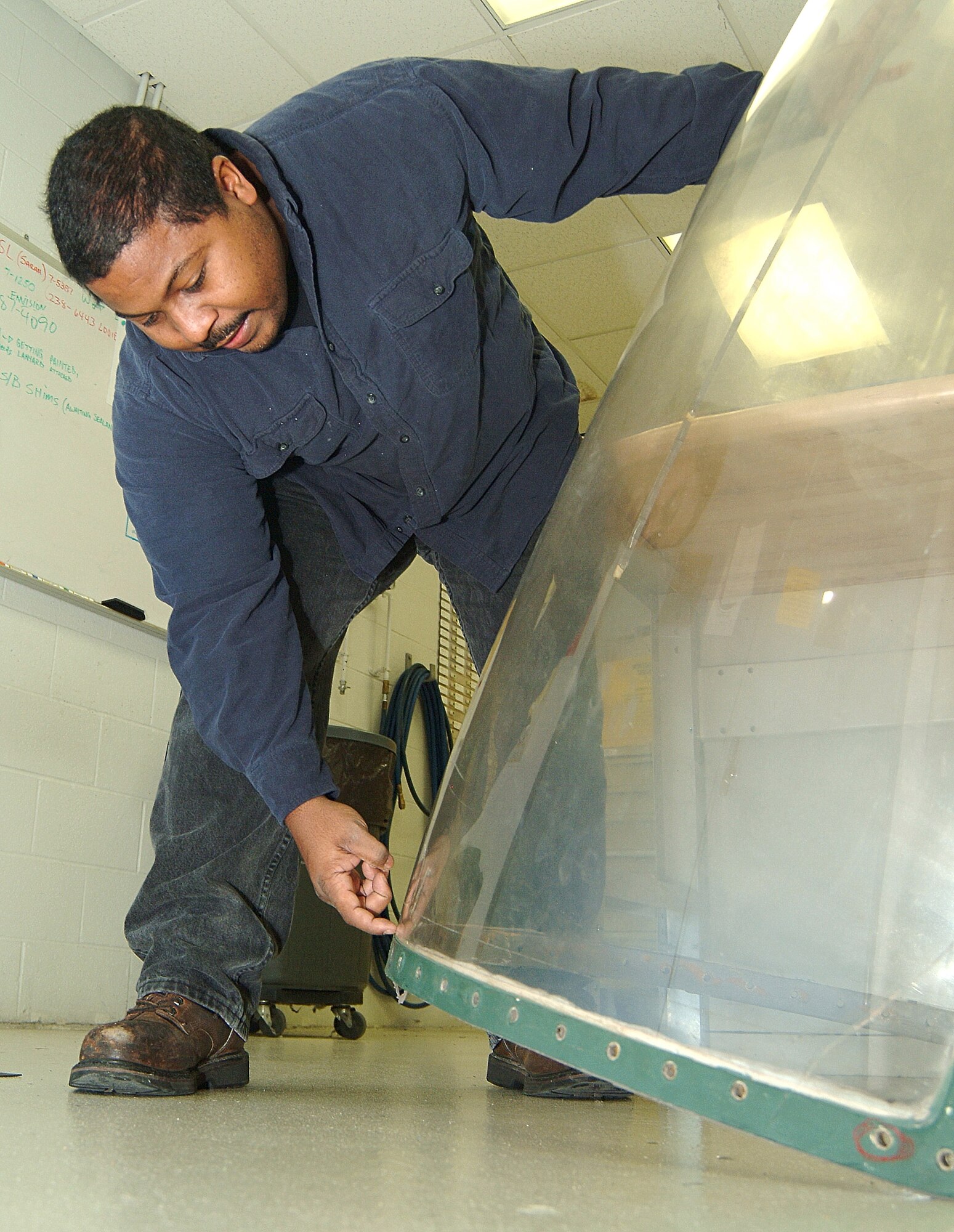 Tech. Sgt. Calvin Carter, an Air Force reservist in the 442nd Maintenance Squadron Metals Technology office, prepares an A-10 canopy for mounting on the 442nd Fighter Wing's new canopy rigging fixture, a device he helped build. While the design of the fixture was more than 30-years old, it had never been built by the Air Force or the A-10's manufacturer, Fairchild Republic. Sergeant Carter and his fellow maintainers overcame several design flaws in the original plan to build the device. His modifications have been adopted by the Air Force as the standard for any unit building a fixture for its A-10s. (U.S. Air Force photo/Master Sgt. Bill Huntington)