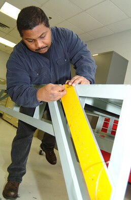 Tech. Sgt. Calvin Carter, an Air Force reservist in the 442nd Maintenance Squadron Metals Technology office, makes some adjustments on the 442nd Fighter Wing's new canopy rigging fixture, a device he helped build. While the design of the fixture was more than 30-years old, it had never been built by the Air Force or the A-10's manufacturer, Fairchild Republic. Sergeant Carter and his fellow maintainers overcame several design flaws in the original plan to build the device. His modifications have been adopted by the Air Force as the standard for any unit building a fixture for its A-10s.  (U.S. Air Force photo/Master Sgt. Bill Huntington)