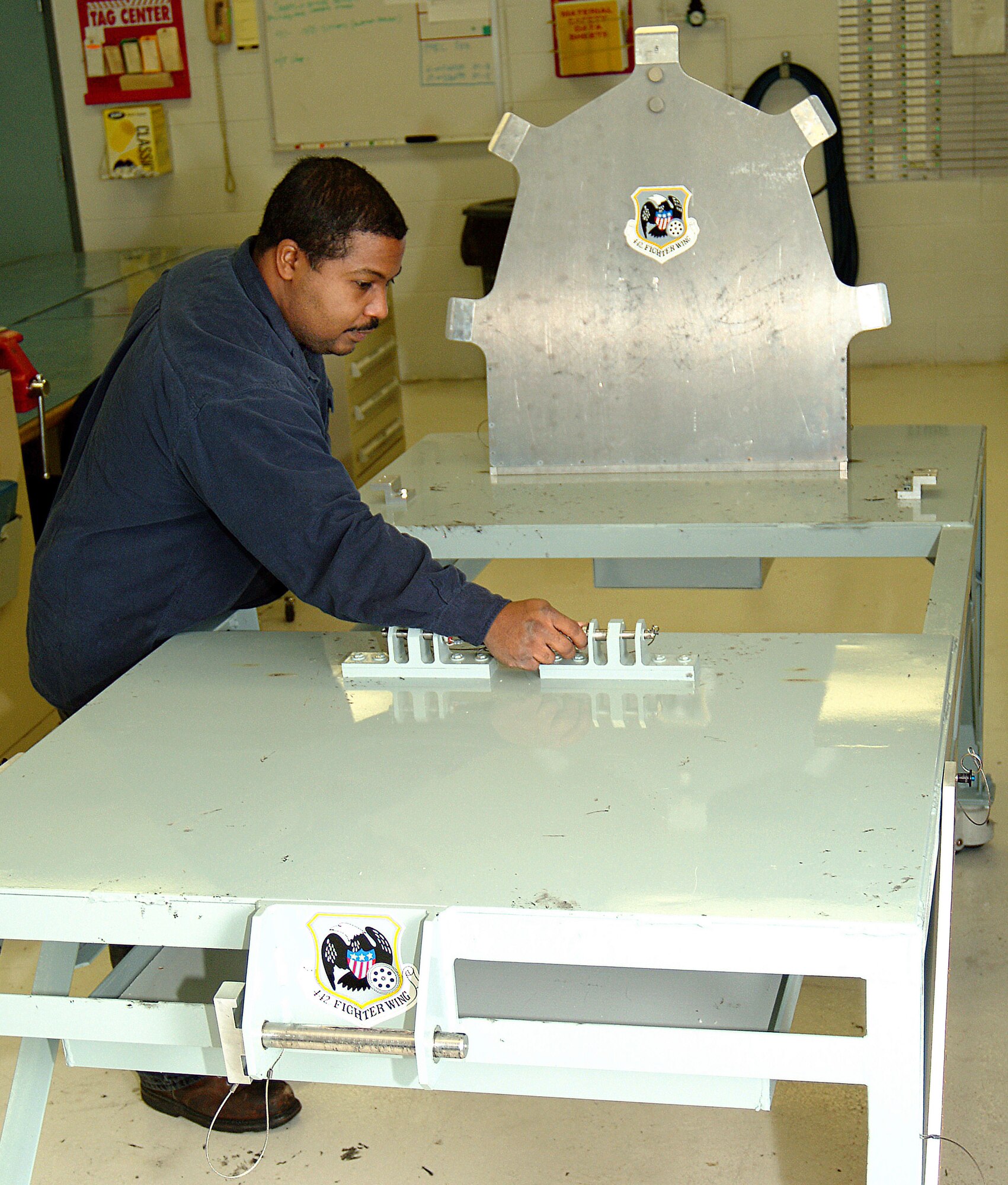 Tech. Sgt. Calvin Carter, an Air Force reservist in the 442nd Maintenance Squadron Metals Technology office, makes adjustments to the 442nd Fighter Wing's new canopy rigging fixture, a device he helped build. While the design of the fixture was more than 30-years old, it had never been built by the Air Force or the A-10's manufacturer, Fairchild Republic. Sergeant Carter and his fellow maintainers overcame several design flaws in the original plan to build the device. His modifications have been adopted by the Air Force as the standard for any unit building a fixture for its A-10s. (U.S. Air Force photo/Master Sgt. Bill Huntington)