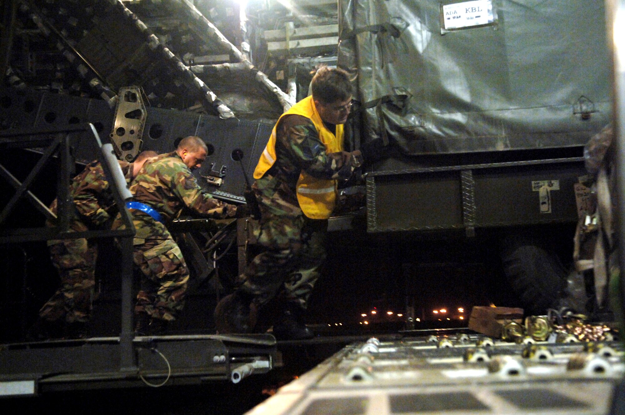 Master Sgt. James Triplett, Staff Sgt. Robert Izzett and Airman 1st Class Thomas Hickey load a trailer onto a C-17 Globemaster III Feb. 20 at Incirlik Air Base, Turkey. Turkish and U.S. Air Forces' joint effort provided 94,000 pounds of supplies and equipment for the Afghan army to use in the war on terrorism. The Airmen are assigned to the 728th Air Mobility Squadron. (U.S. Air Force photo/Airman 1st Class Nathan W. Lipscomb)