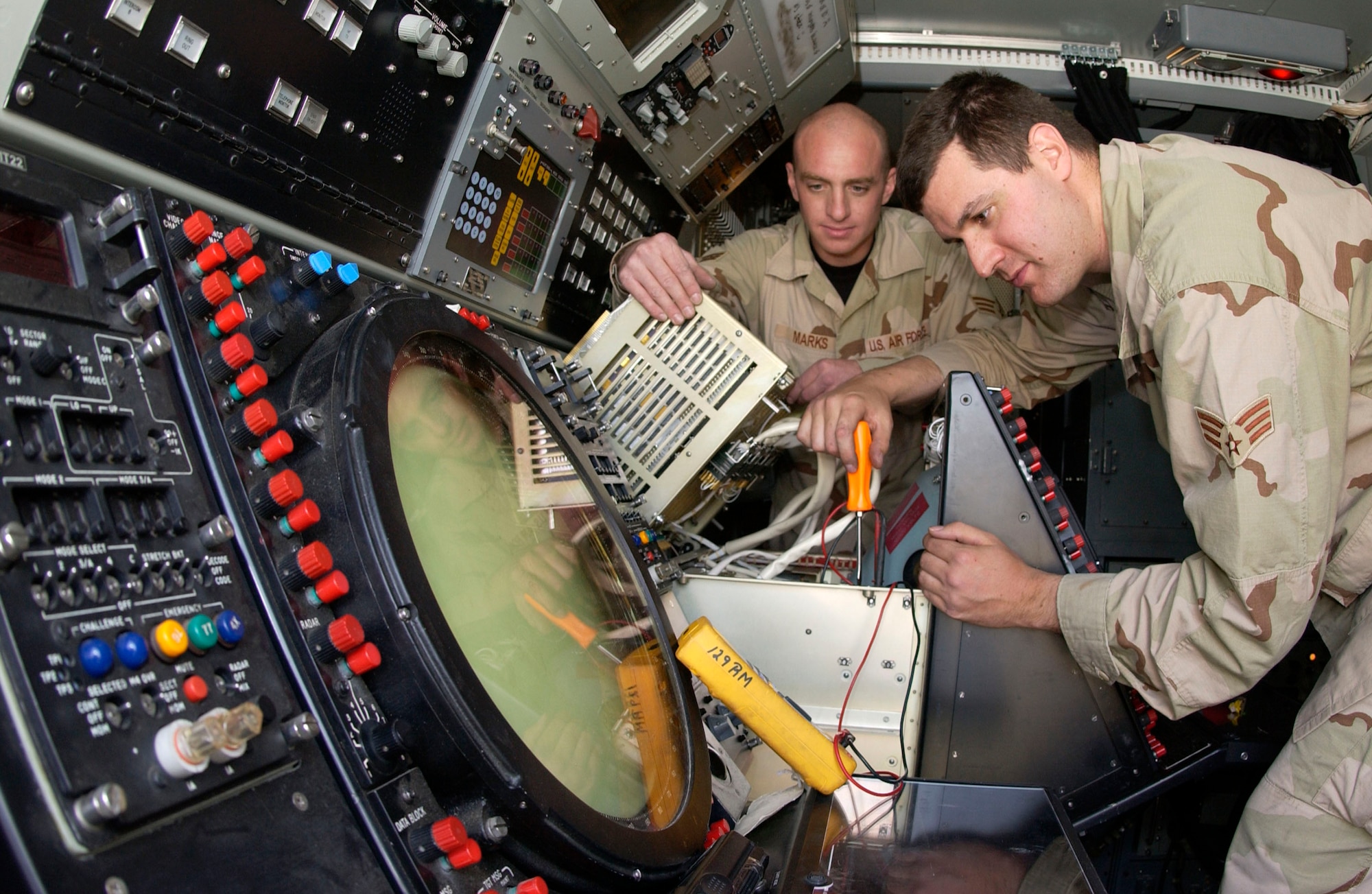 Senior Airmen Timothy Marks and Christopher Newton test a display unit on an AN/TPS-75 air surveillance radar Feb. 27 at Kirkuk Regional Air Base, Iraq. The AN/TPS-75 allows air battle managers located at Balad AB, Iraq, to remotely see aircraft flying in northern Iraq. Both Airmen are ground radar systems techinicians with the 727th Expeditionary Air Control Squadron. (U.S. Air Force photo/Senior Airman Bradley A. Lail) 
