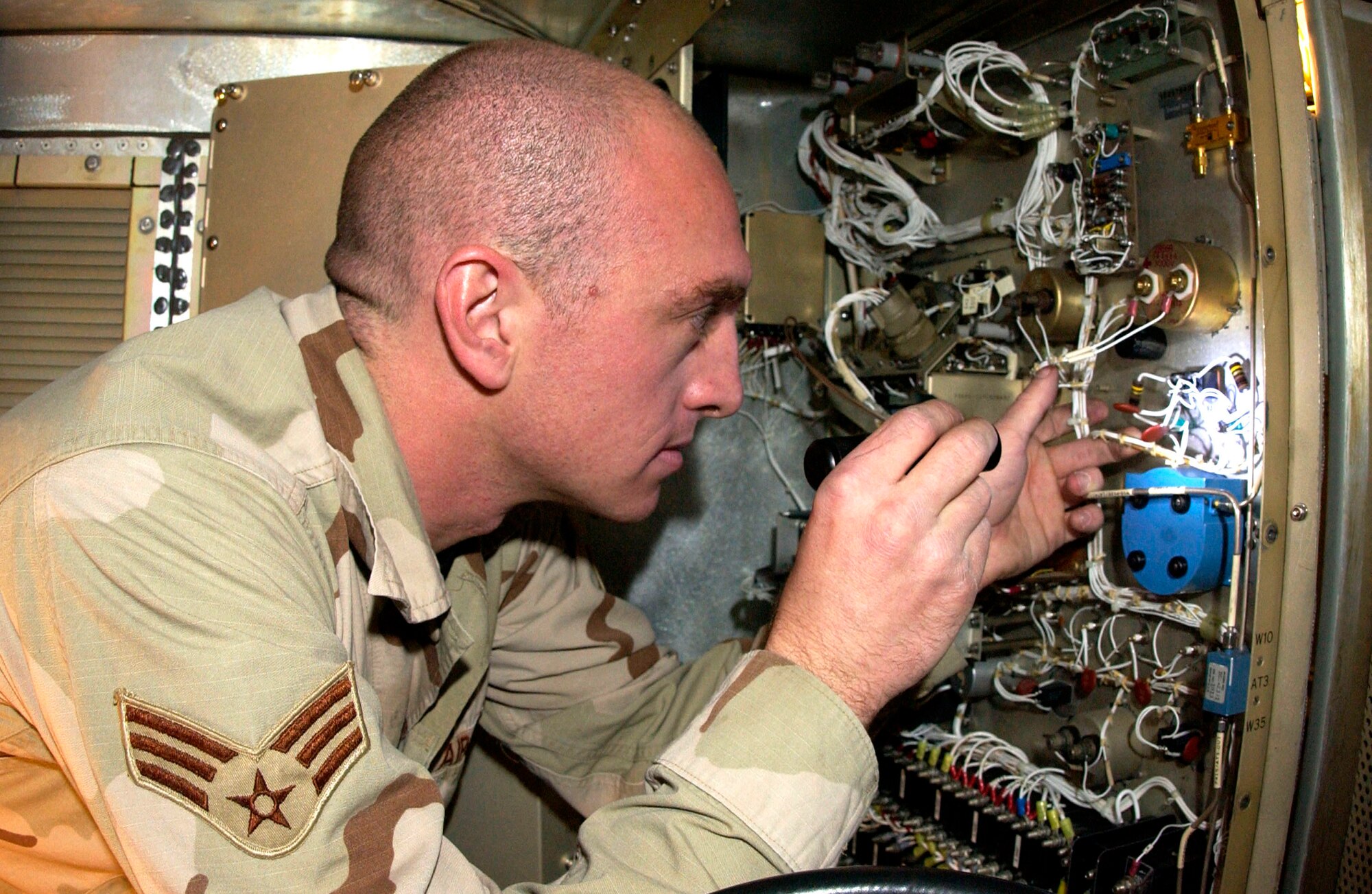 Senior Airman Timothy Marks repairs a damaged component of an AN/TPS-75 air surveillance radar Feb. 27 at Kirkuk Air Base, Iraq. The AN/TPS-75 allows air battle managers located at Balad AB, Iraq, to remotely see aircraft flying in northern Iraq. Airman Marks is a ground radar systems techinician with the 727th Expeditionary Air Control Squadron. (U.S. Air Force photo/Senior Airman Bradley A. Lail) 
