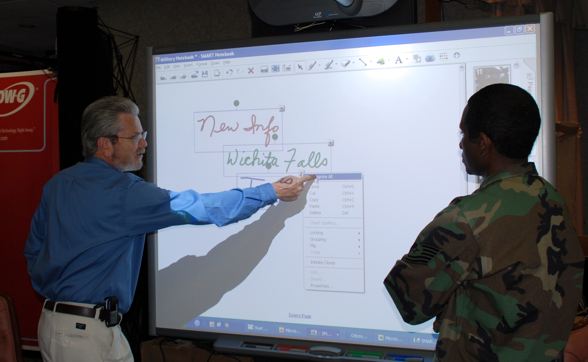 Bill McCarty, federal manager of the Visual Innovations Company, demonstrates the use of an interactive electronic whiteboard to Tech. Sgt. Corey Boyd, an instructor with the 361st Training Squadron, at the 5th Annual Sheppard Tech Expo Feb. 27. (U.S. Air Force photo/Airman 1st Class Jacob Corbin)