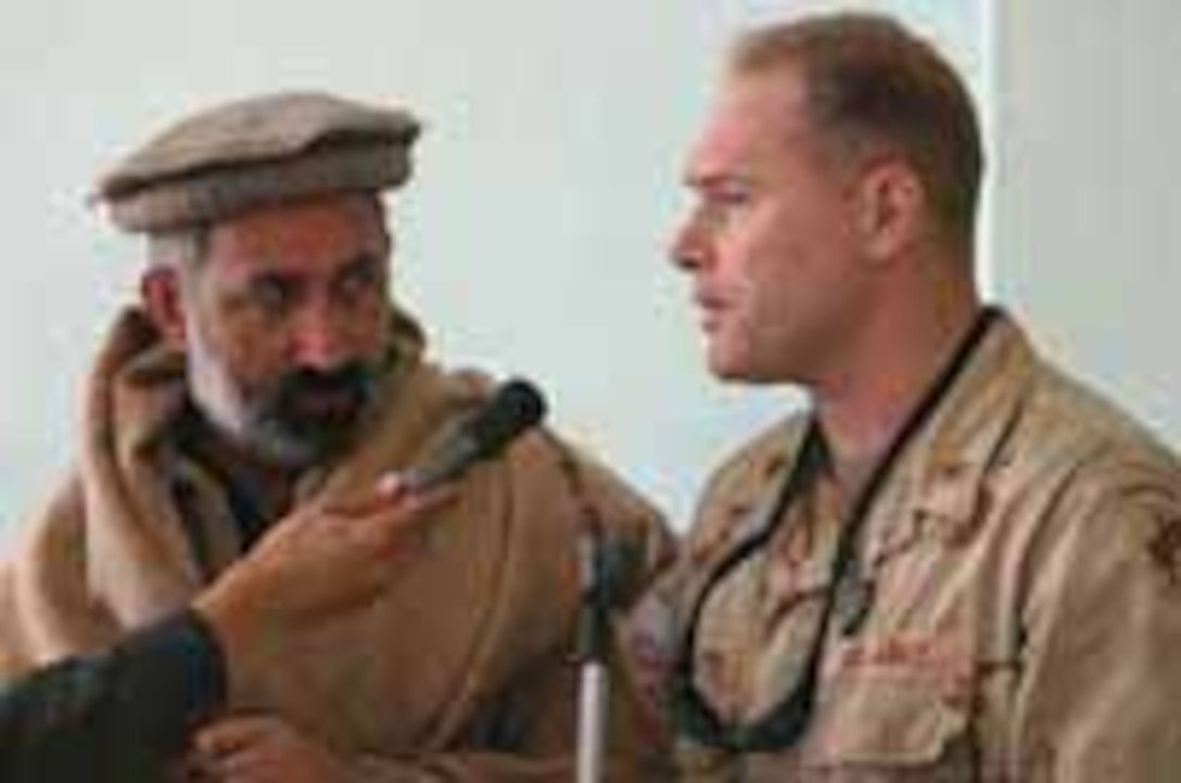 Maj. Carl Hollister, commander of the Khowst provincial reconstruction team, speaks at a mullah conference Dec. 6 at Khowst (Afghanistan) University. Photo by Cpl. Justin Schaeffer