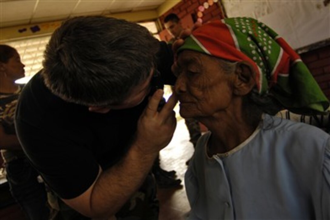 U.S. Air Force Maj. Michael Osterhoudt examines a woman's eyes during a medical readiness training exercise in Santa Teresa, Nicaragua, Feb. 26, 2007, as part of New Horizons-Nicaragua 2007. The joint humanitarian and training exercise with the Nicaraguan military will provide a new school, and a medical clinic. 