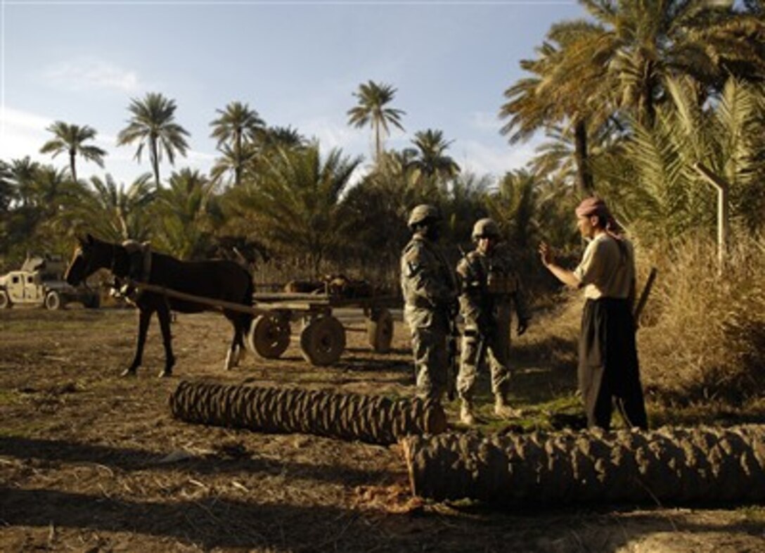 U.S. Army soldiers from Delta Company, 1st Cavalry Division, 12th Infantry Regiment, speak to a farmer while performing a foot patrol in Khalis, Iraq, Feb. 21, 2007.