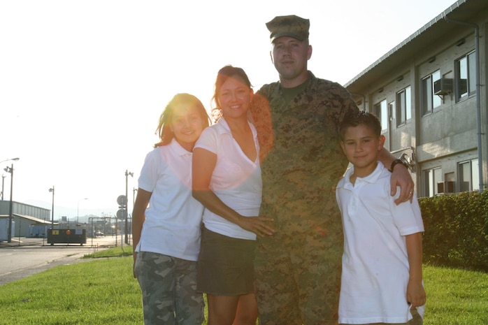 Standing tall with his family, Staff Sgt. Christopher W. Hester, Marine Aviation Logistics Squadron 12 Headquarters operations chief and native of Tucson, Ariz., enters a turning point in his Marine Corps career by entering the Enlisted Commissioning Program. He leaves for Officer Candidate School September 7.