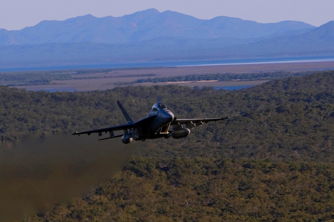 TOWNSHEND ISLAND, SHOALWATER BAY TRAINING AREA, QUEENSLAND, Australia – An F-18 Hornet from the USS Kittyhawk soars over its designated target area during a fire-support mission here, July 1. The fire mission was part of a four-day fire-support team training exercise involving personnel of the 3rd Marine Expeditionary Brigade’s 31st Marine Expeditionary Unit and their Australian counterparts during Exercise Talisman Saber 2007. Talisman Saber is conducted to train an U.S. and Australian joint task force and operations staff in crisis action planning for execution of contingency operations. The exercise involves more than 32,000 personnel from both nations that will focus on improving interoperability and enhancing regional stability.