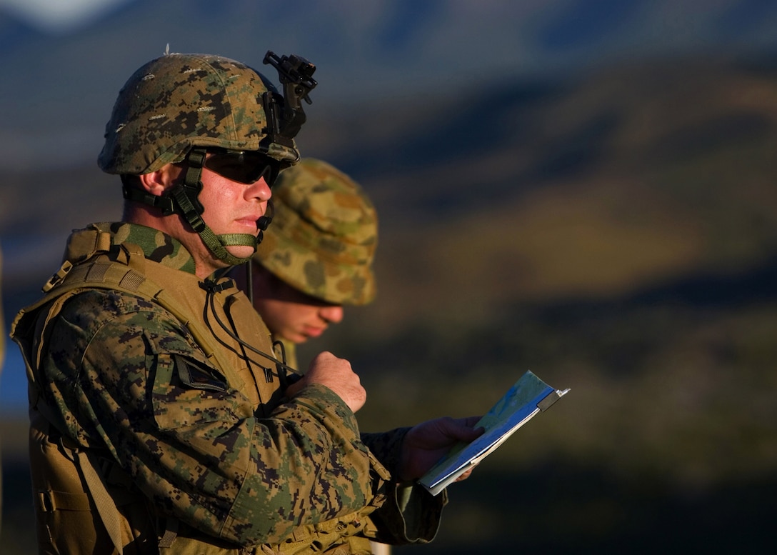 TOWNSHEND ISLAND, SHOALWATER BAY TRAINING AREA, QUEENSLAND, Australia ? Capt. Jones Warren, a forward air controller with the 31st Marine Expeditionary Brigade?s 31st Marine Expeditionary Unit, Battalion Landing Team, 2nd Battalion, 1st Marine Regiment, communicates with pilots during a fire support mission here, July 1, as a part of a fire-support team training exercise. The four-day exercise was conducted during Exercise Talisman Saber 2007. Talisman Saber is conducted to train an U.S. and Australian joint task force and operations staff in crisis action planning for execution of contingency operations. The exercise involves more than 32,000 personnel from both nations that will focus on improving interoperability and enhancing regional stability.