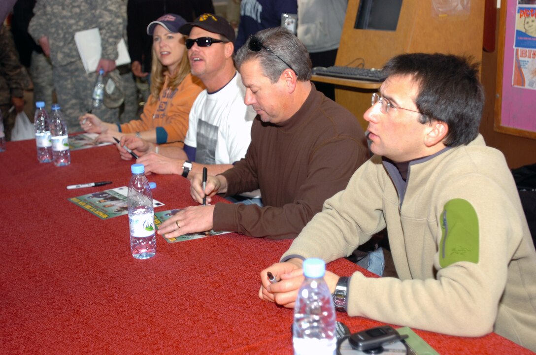 From left: Actress Karri Turner, Jim McMahon, Kevin Butler and news personality Dave Price sign autographs for Third Army/ U.S. Army Central servicemembers during the Stars for Stripes “Ringin’ in the New Year” tour at Camp Arifjan, Kuwait, Jan. 1, 2007. Photo by Staff Sgt. Patrick Moes, USA