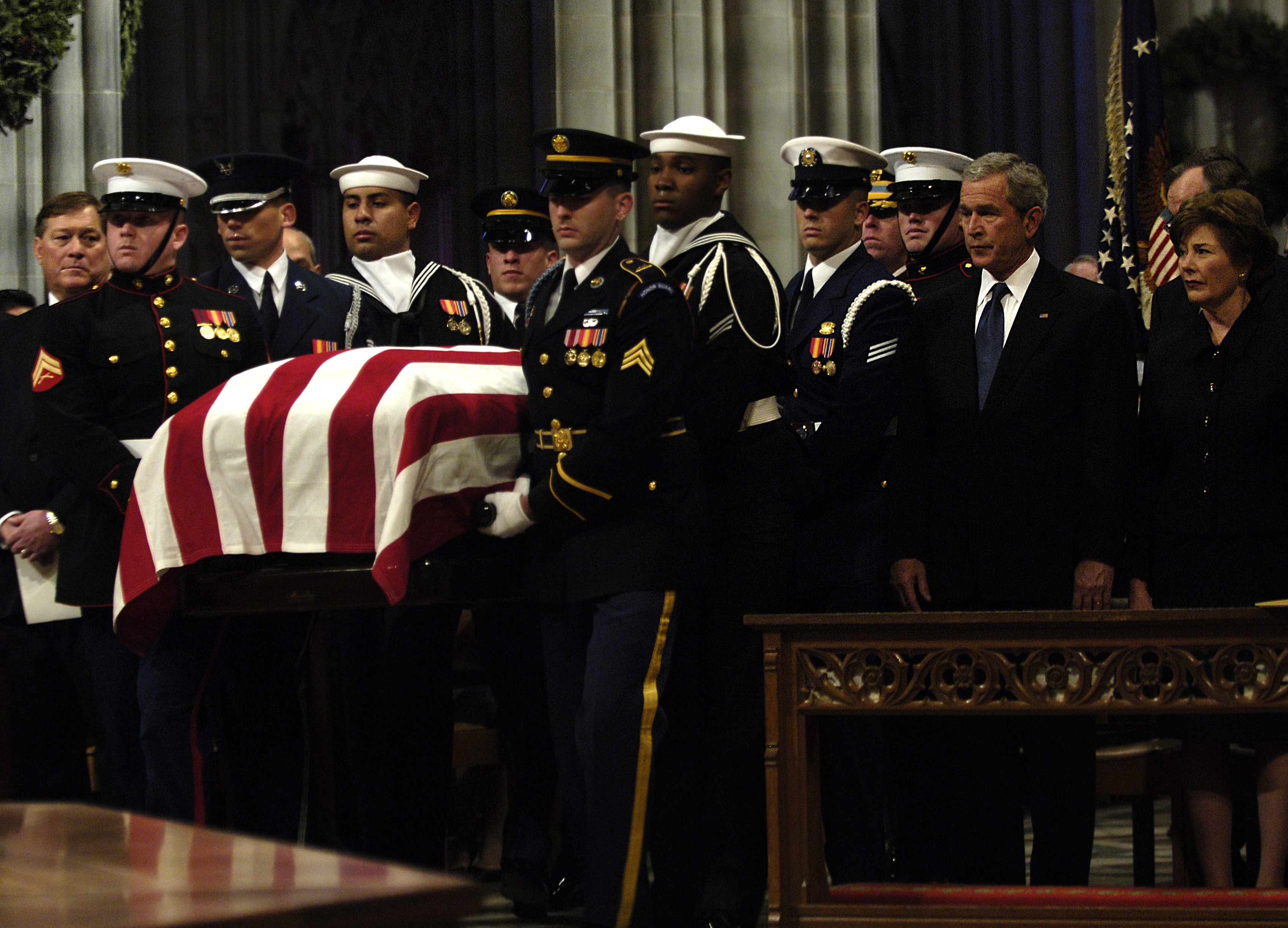 The casket of former U.S. President Gerald Ford is carried past U.S.  President George W. Bush