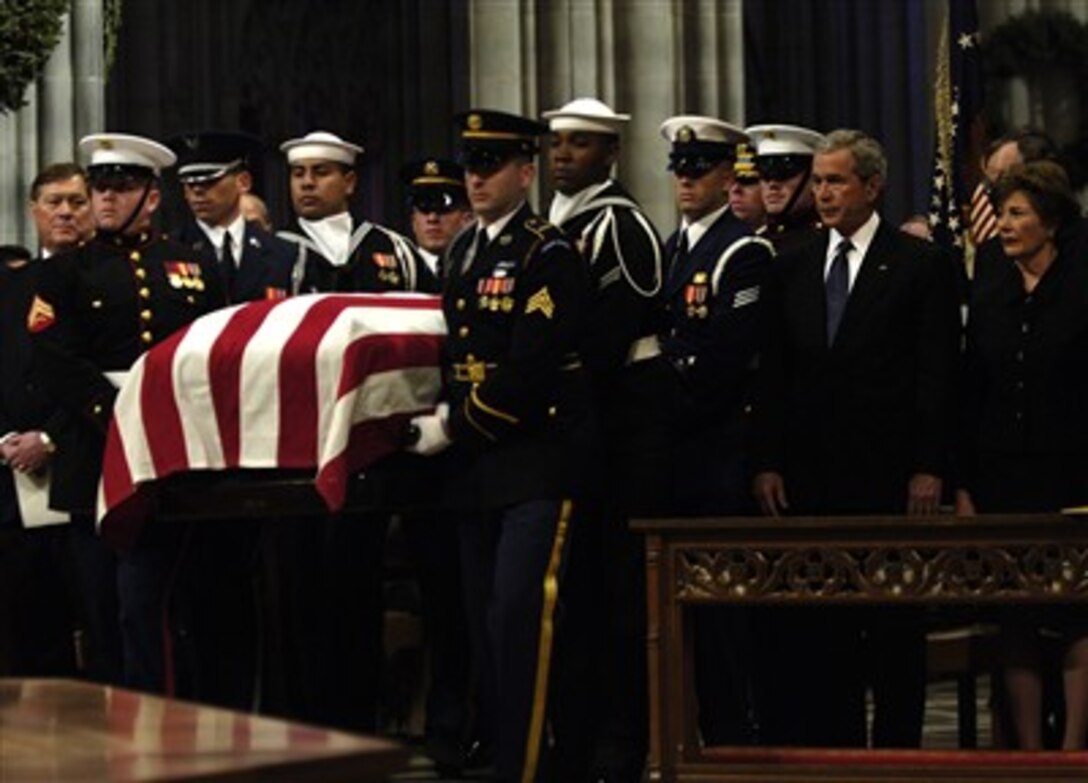 The casket of former President Ford is carried past President George W. Bush and first lady Laura Bush during Ford's state funeral in Washington, D.C., Jan. 2, 2007. 