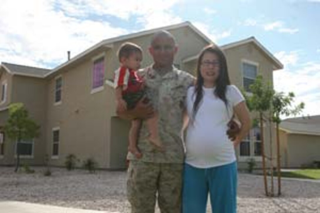 Sgt. Kenny W. Padillapaniagua, Headquarters and Headquarters Squadron supply administrative chief, stands with his family in front of his home here Oct. 2. Padillapaniagua was on terminal leave when he decided to reenlist because he and his wife missed the military and the benefits, such as having a home in station housing.