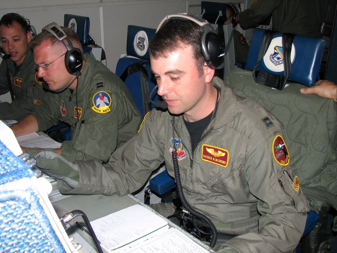From left, Captains Matt Ketchie, Tim Higgins and Patrick McSherry work during an E-3 Sentry mission Dec. 21 over Ecuador. The three are deployed to Manta Forward Operating Location, Ecuador, from Tinker Air Force Base, Okla. Captain Ketchie and McSherry are air weapons officers, and Captain Higgins is a senior director. The Airmen coordinate with agencies to provide better imagery. (U.S. Air Force photo/2nd Lt. Amber Balken)