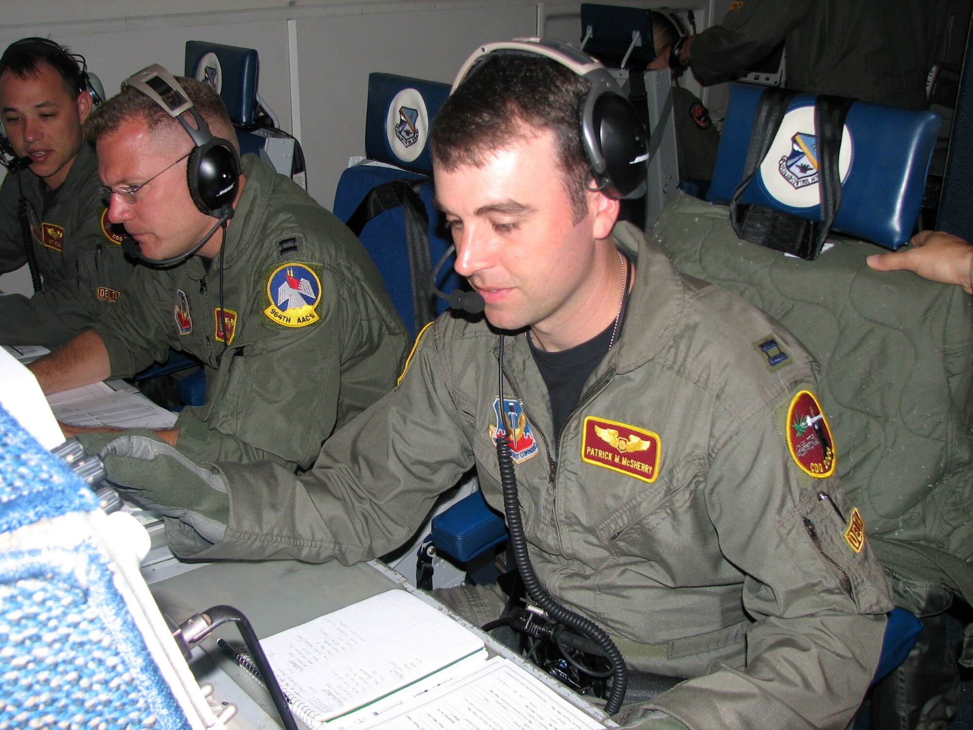 From left, Captains Matt Ketchie, Tim Higgins and Patrick McSherry work during an E-3 Sentry mission Dec. 21 over Ecuador. The three are deployed to Manta Forward Operating Location, Ecuador, from Tinker Air Force Base, Okla. Captain Ketchie and McSherry are air weapons officers, and Captain Higgins is a senior director. The Airmen coordinate with agencies to provide better imagery. (U.S. Air Force photo/2nd Lt. Amber Balken)
