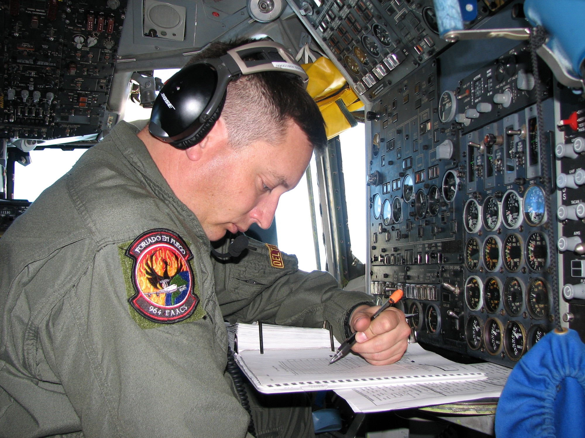 Tech. Sgt. Erich Ross runs through operational checklists during an E-3 Sentry mission Dec. 21 over Ecuador. Sergeant Ross is a flight engineer with the 964th Expeditionary Airborne Air Control Squadron. (U.S. Air Force photo/2nd Lt. Amber Balken) 
