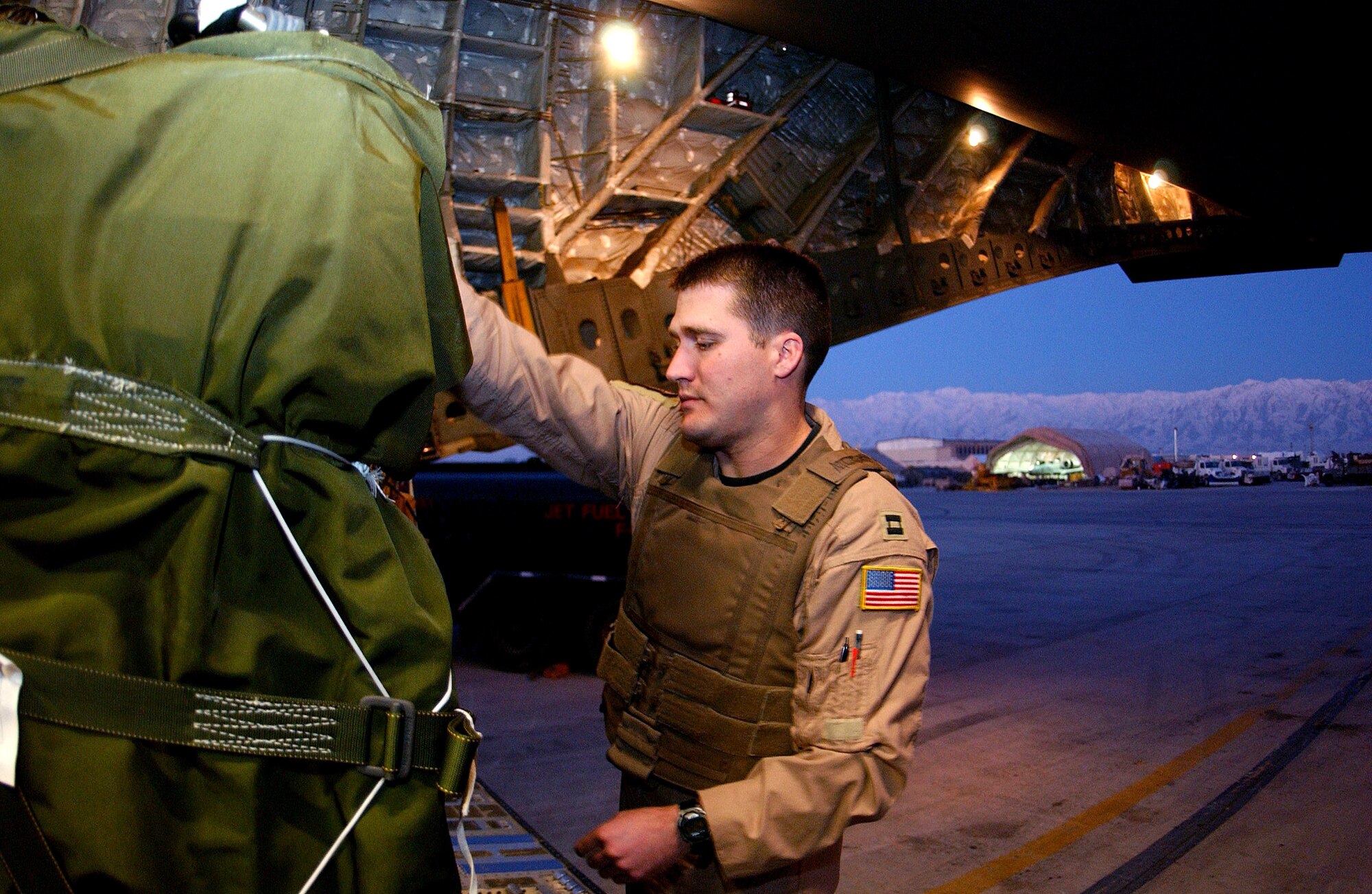 Capt. Matthew Inscoe checks pallets that his crew will be airdropping to servicemembers at remote camps Jan. 2 in Afghanistan. The aircraft and crew are from a desert air base in Southwest Asia. Captain Inscoe the aircraft commander of a C-17 Globemaster III with the 816th Expeditionary Airlift Squadron. (U.S. Air Force photo/Senior Airman Ricky J. Best) 
