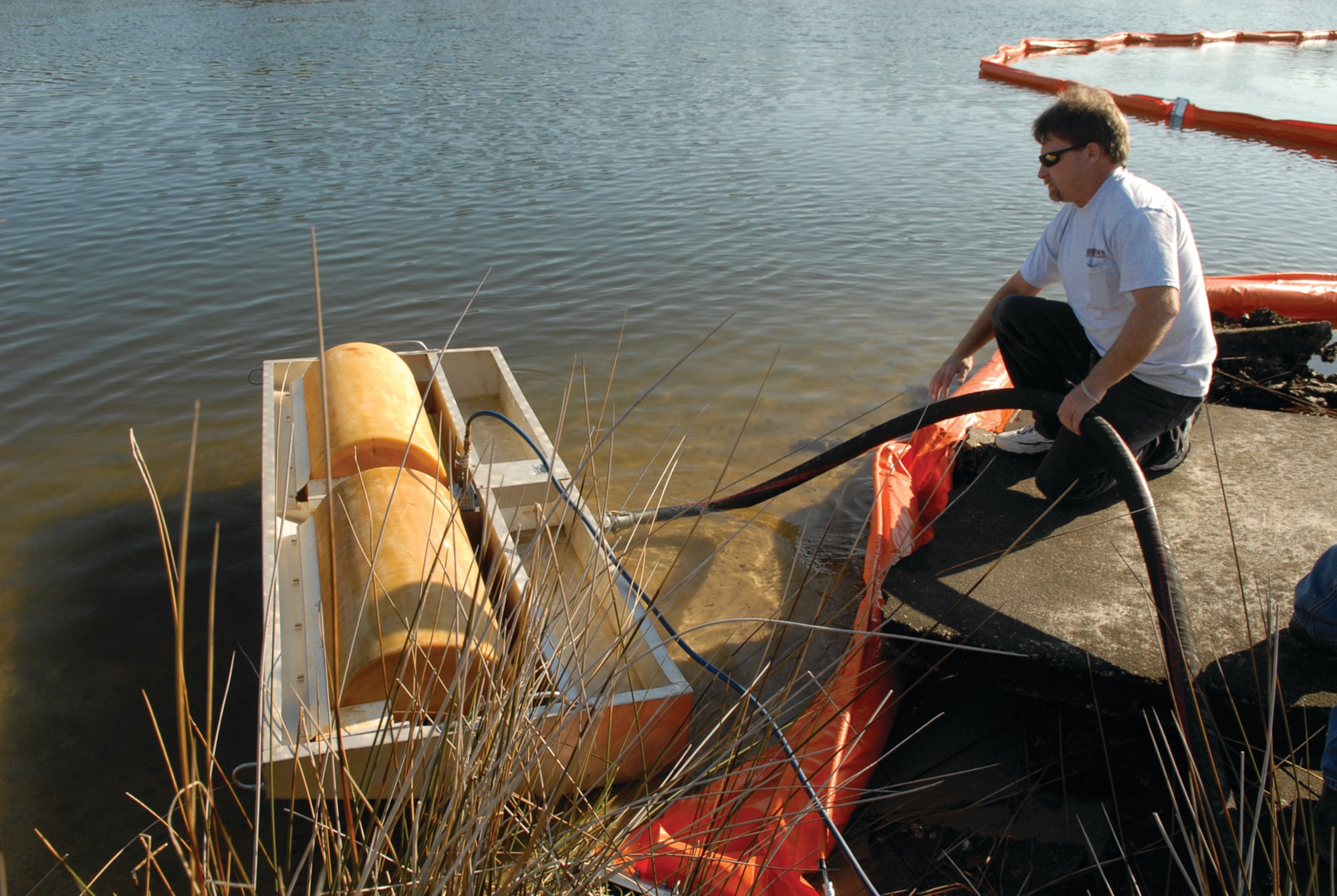 D.J. Skaggs, 325th CES spill contractor, utilizes a skimmer unit to recover spilled material from the water. 