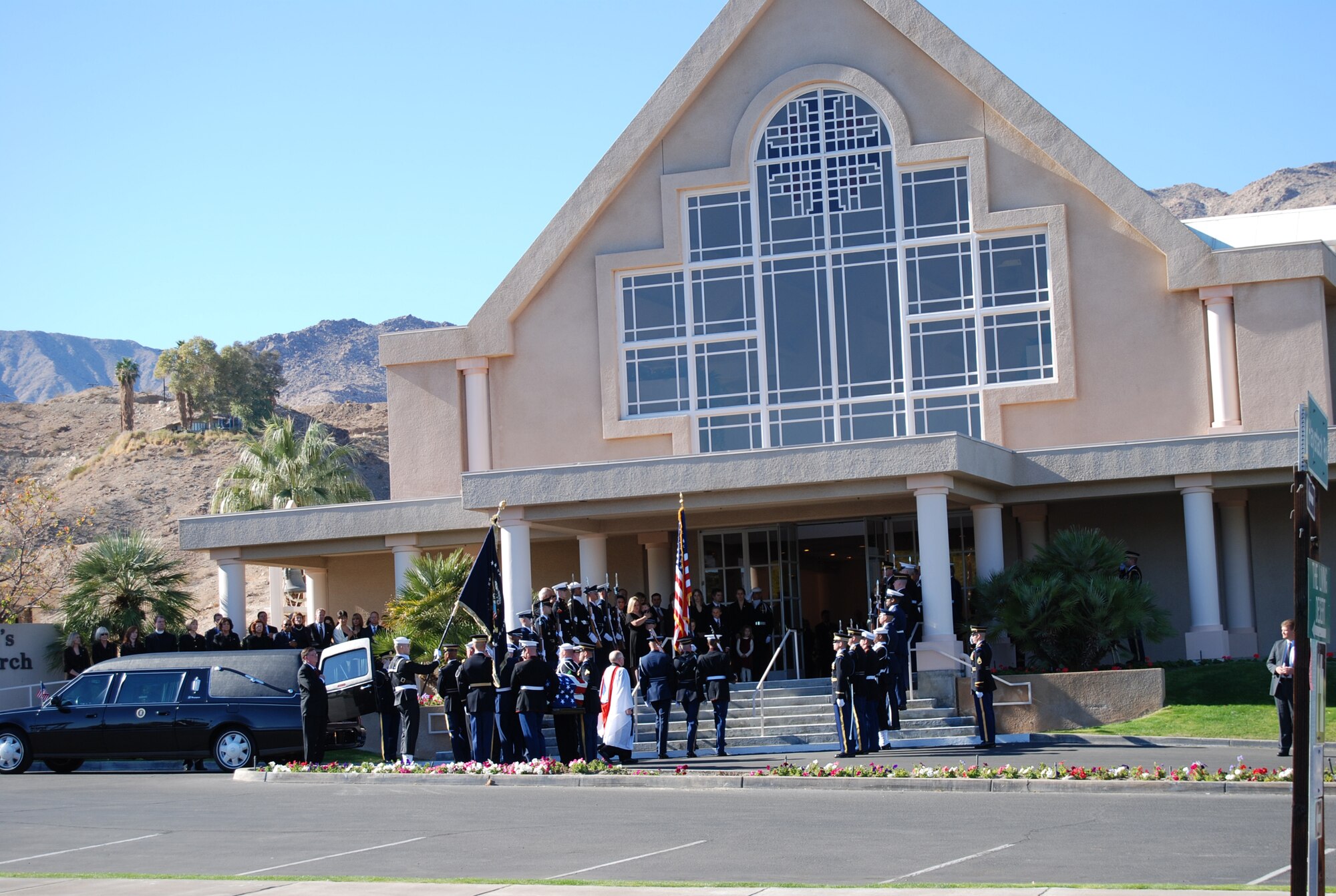 The casket of the former President Gerald R. Ford is carried between the ranks of honorary pallbearers and honor cordon into St. Margaret's Episcopal Church in Palm Springs, California, Dec. 29 for a private family prayer service. More than 500 military members are in Palm Desert supporting the California portion of the State Funeral for the former president. The military is providing ceremonial, logistics, and security support to honor and pay tribute to the former Commander-in-Chief and the Ford family. Ford died in Palm Desert, California, Dec. 26 at the age of 93. (U.S. Air Force Photo/1st Lt Carrie L. Kessler)