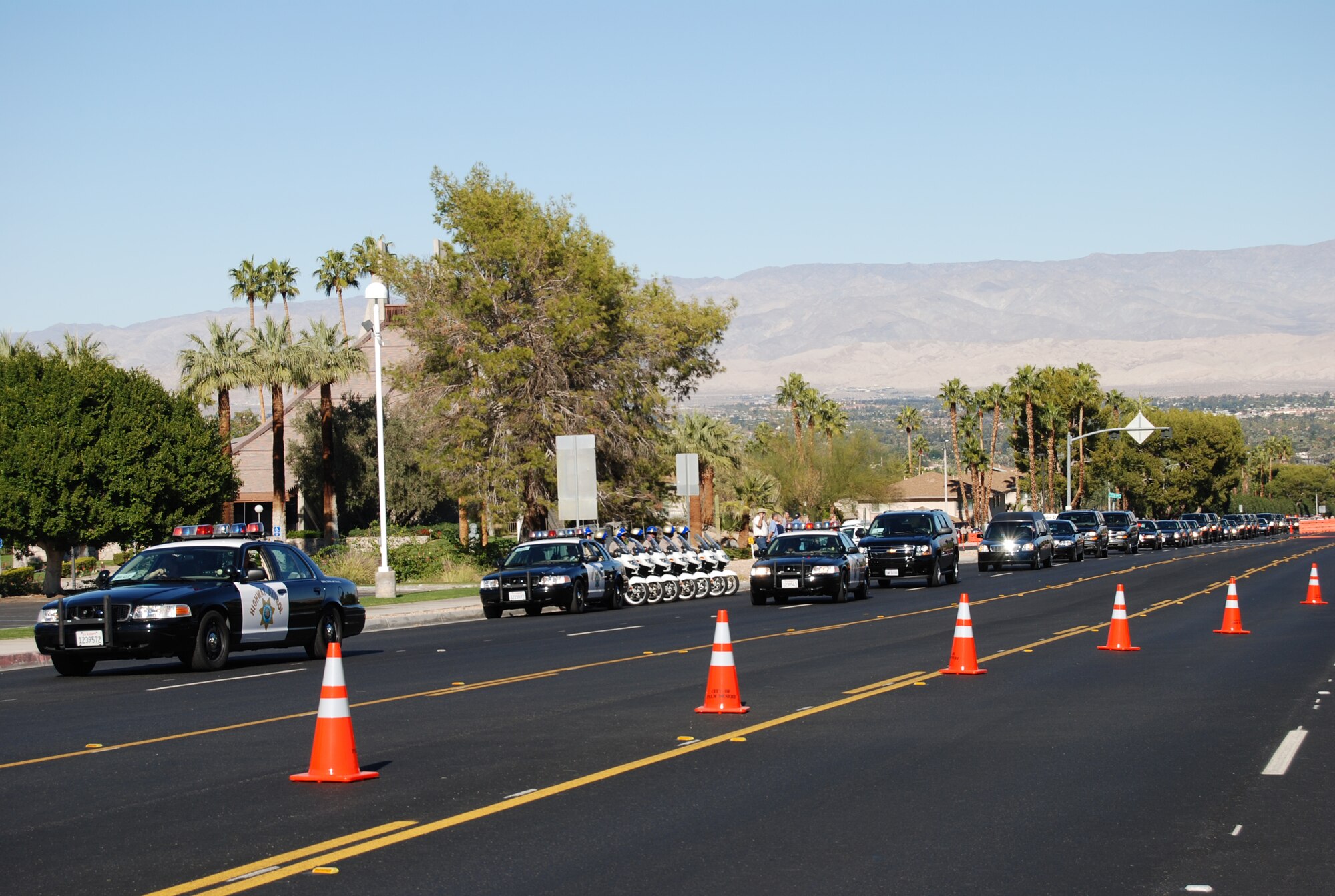 The former President Gerald R. Ford motorcade advances along Highway 74 Dec. 29 en route to St. Margaret's Episcopal Church in Palm Desert, California, for the private family prayer service. More than 500 military members are in Palm Desert supporting the California portion of the State Funeral for former President Gerald R. Ford. The military is providing ceremonial, logistics, and security support to honor and pay tribute to the former Commander-in-Chief and the Ford family. Ford died in Palm Desert, California, Dec. 26 at the age of 93. (U.S. Air Force Photo/1st Lt Carrie L. Kessler)