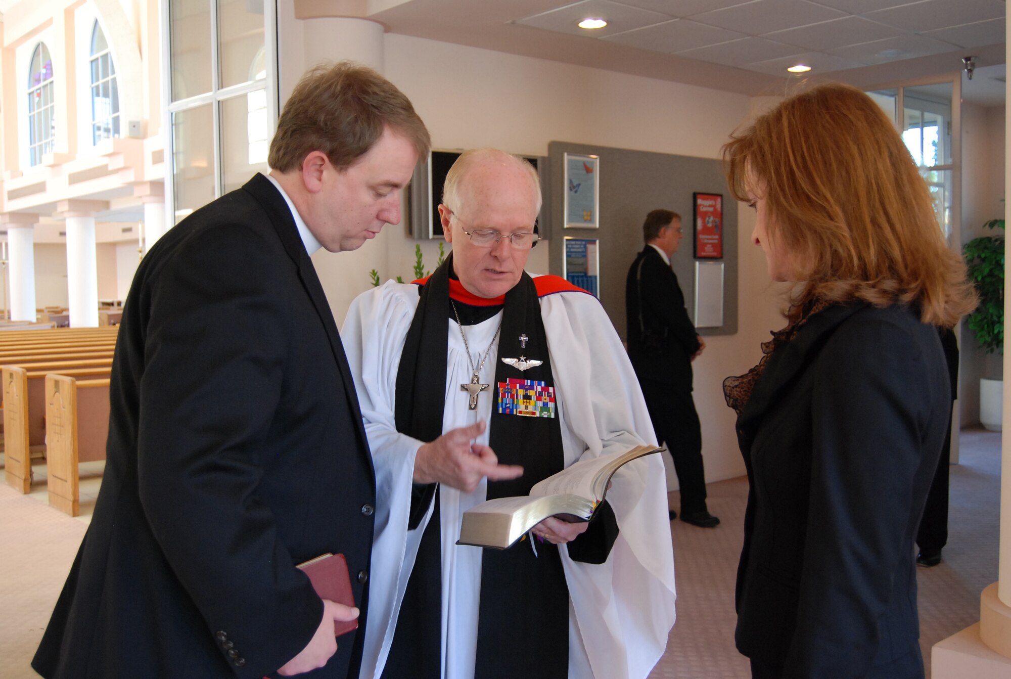Reverend Dr. (US Air Force Ret. Col.) Robert G. Certain, St. Margaret's Episcopal Church and School rector in Palm Desert, California, reviews scripture with Father Brooks Keith, Beaver Creek, Colorado, as his wife Julie Keith looks on prior to the private family prayer service for former President Gerald R. Ford. Reverend Certain served as an Air Force Chaplain for the crew of Air Force One during the Ford administration as well as pastor to President and Mrs. Ford at St. Margaret's. 
'It's been a blessing to be associated with his family and this parish," said Reverend Certain. More than 500 military members are in Palm Desert supporting the California portion of the State Funeral for the former president. The military is providing ceremonial, logistics, and security support to honor and pay tribute to the former Commander-in-Chief and the Ford family. Ford died in Palm Desert, California, Dec. 26 at the age of 93. (U.S. Air Force Photo/1st Lt Carrie L. Kessler)