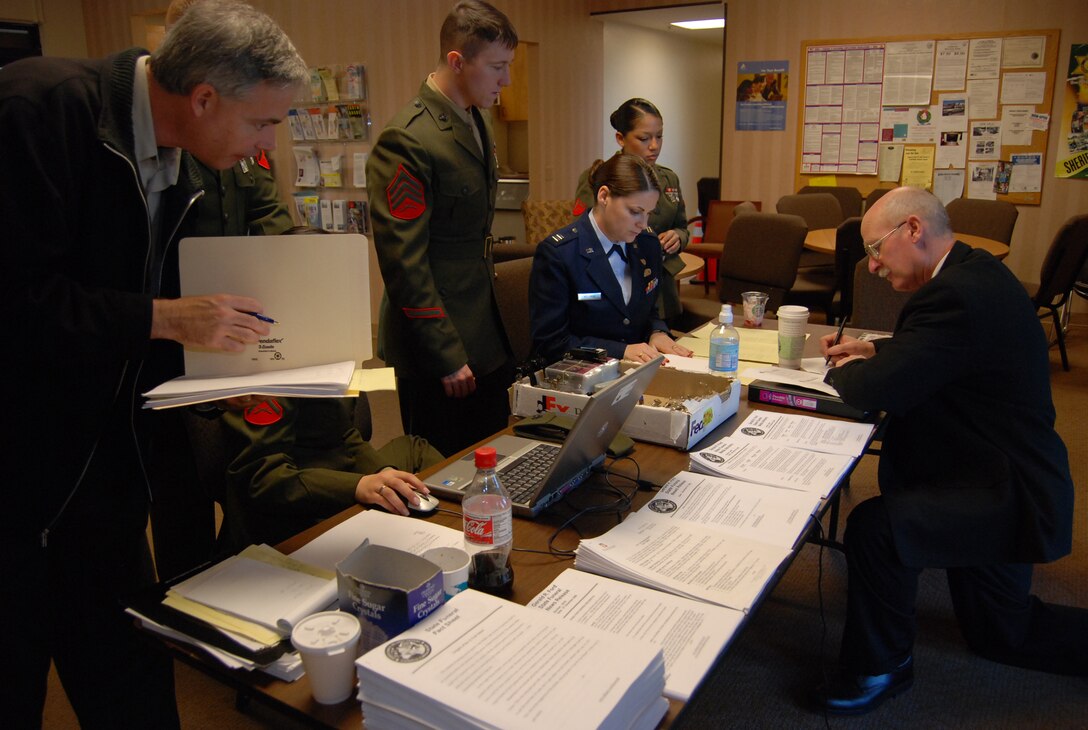 Joint Information Bureau members prepare the media credentialing center Dec. 29 to receive the 374 media representatives covering services in Palm Desert, California, for former President Gerald R. Ford. More than 500 military members are in Palm Desert supporting the California portion of the State Funeral for the former president. (U.S. Air Force Photo/1st Lt Carrie L. Kessler)