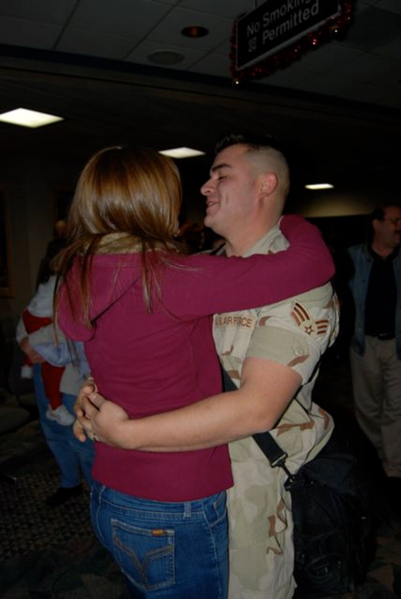 Senior Airman Francisco Salcedo, 28th Civil Engineer Squadron, hugs his wife Amber after returning Dec. 22 from a 7-month deployment to Contingency Operating Base Speicher, Iraq. Airman Salcedo was one of 42 28th CES Airmen deployed in support of the continuing global war on terrorism and responsible for maintaining base infrastructure in their overseas location.