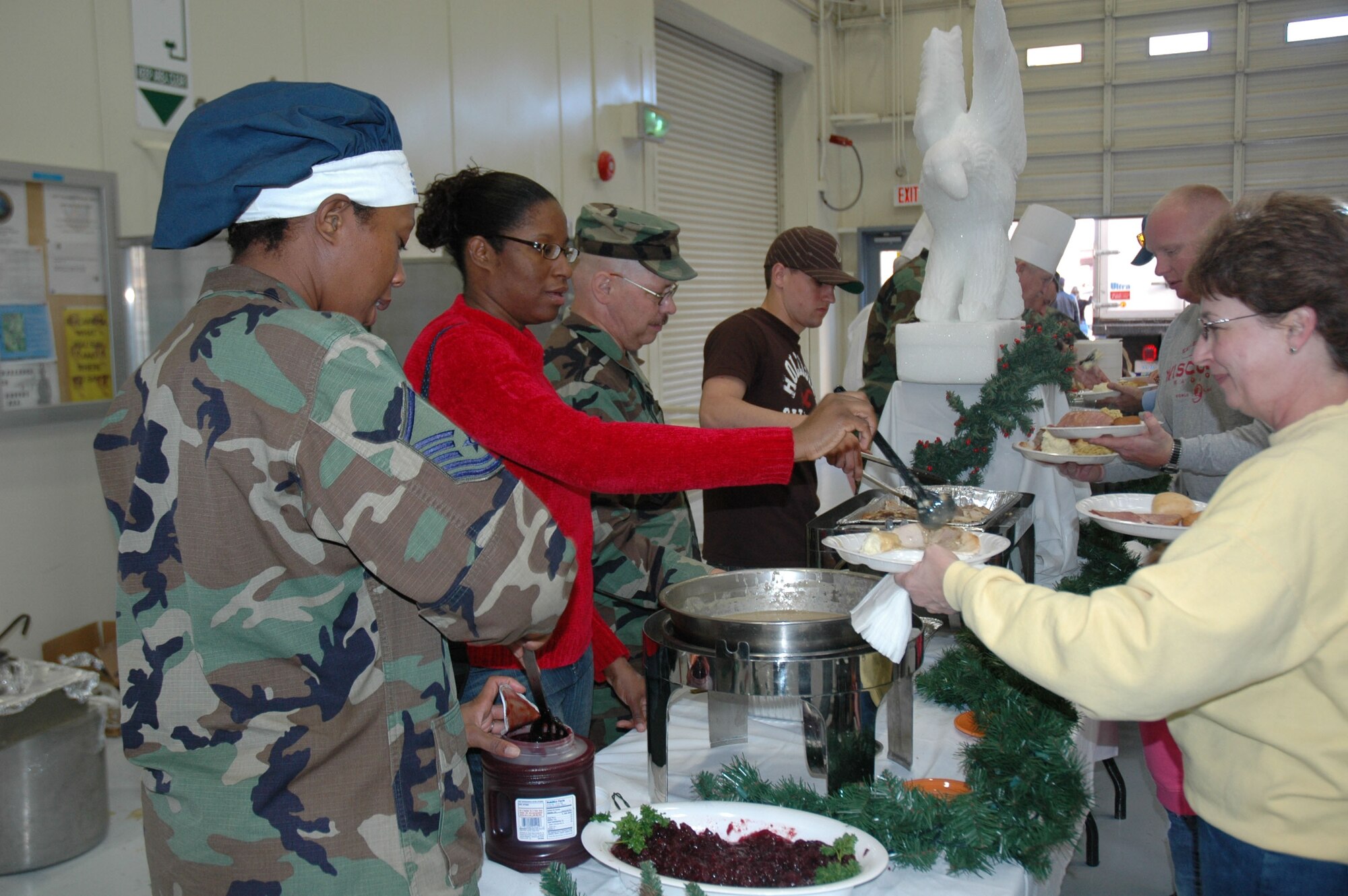 Members of the 944th Services Squadron prepared a traditional holiday dinner in the base dining facility with the assistance of volunteers from the Art Institute of Phoenix Culinary Department for the 944th Fighter Wing's annual holiday picnic Dec. 3. The volunteers were culinary students and the institute's master chef. (U.S. Air Force photo/Staff Sgt. Stephen Razo)